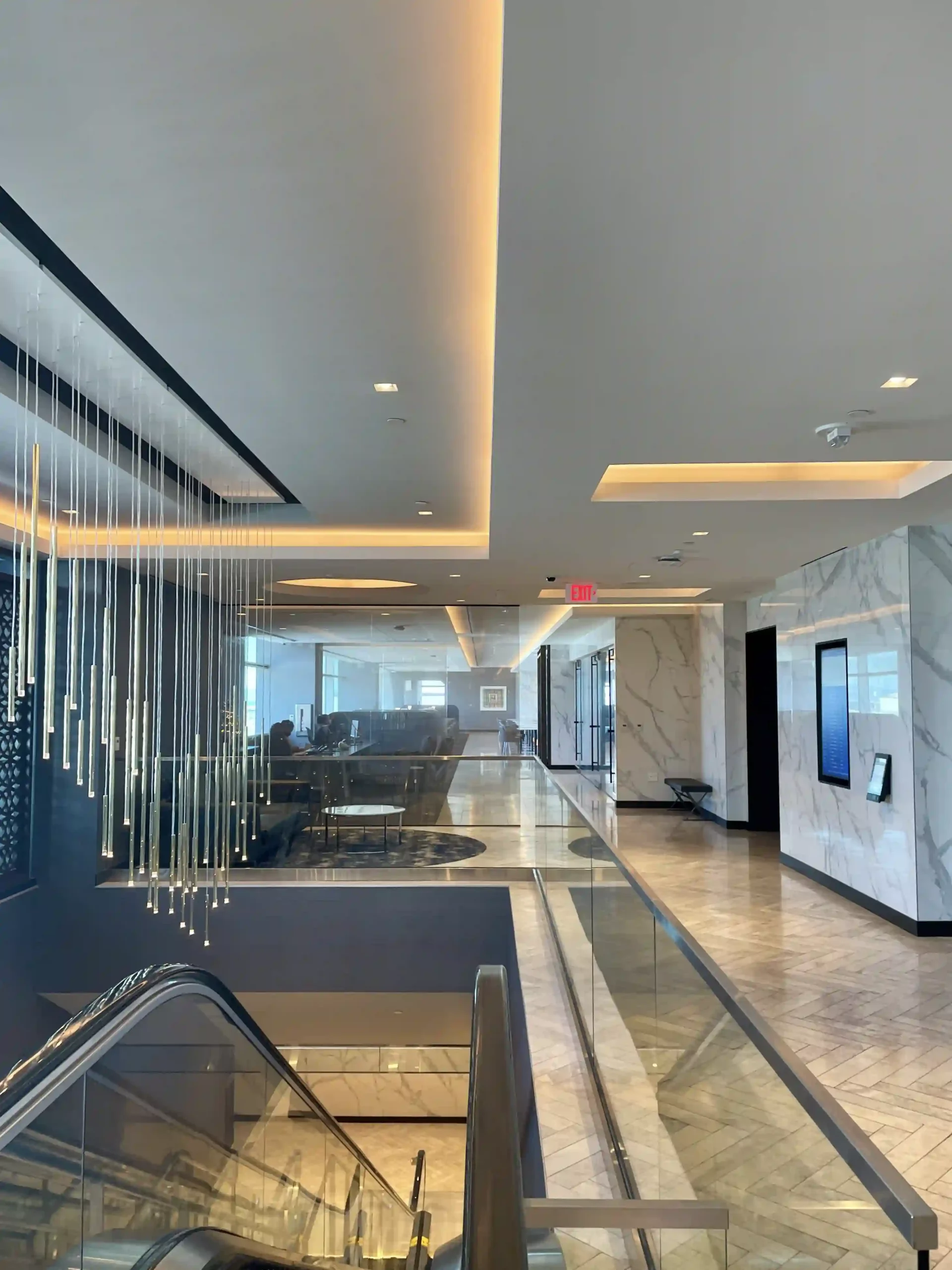 a lobby with a staircase and a glass wall