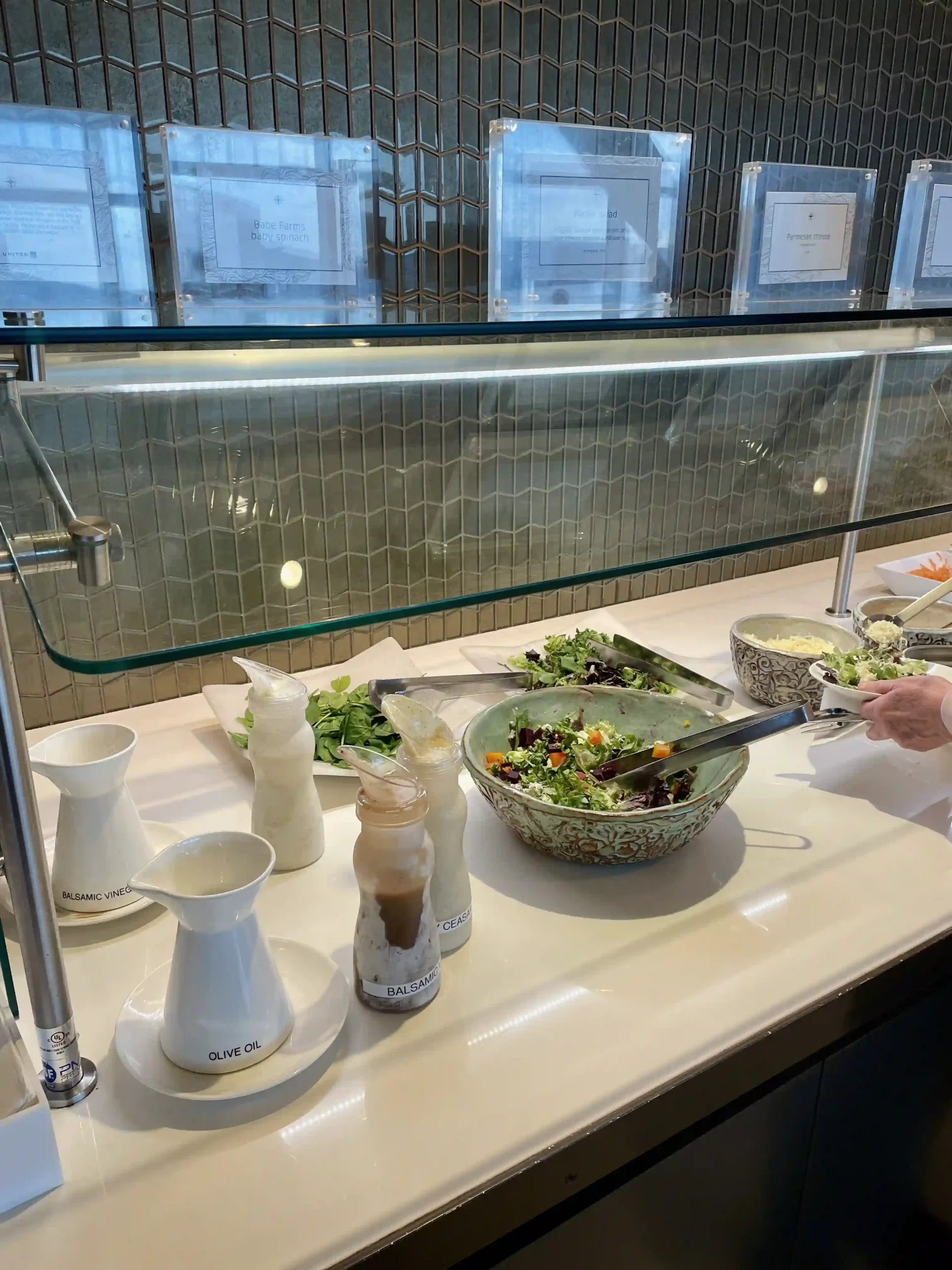 a person preparing food in a buffet