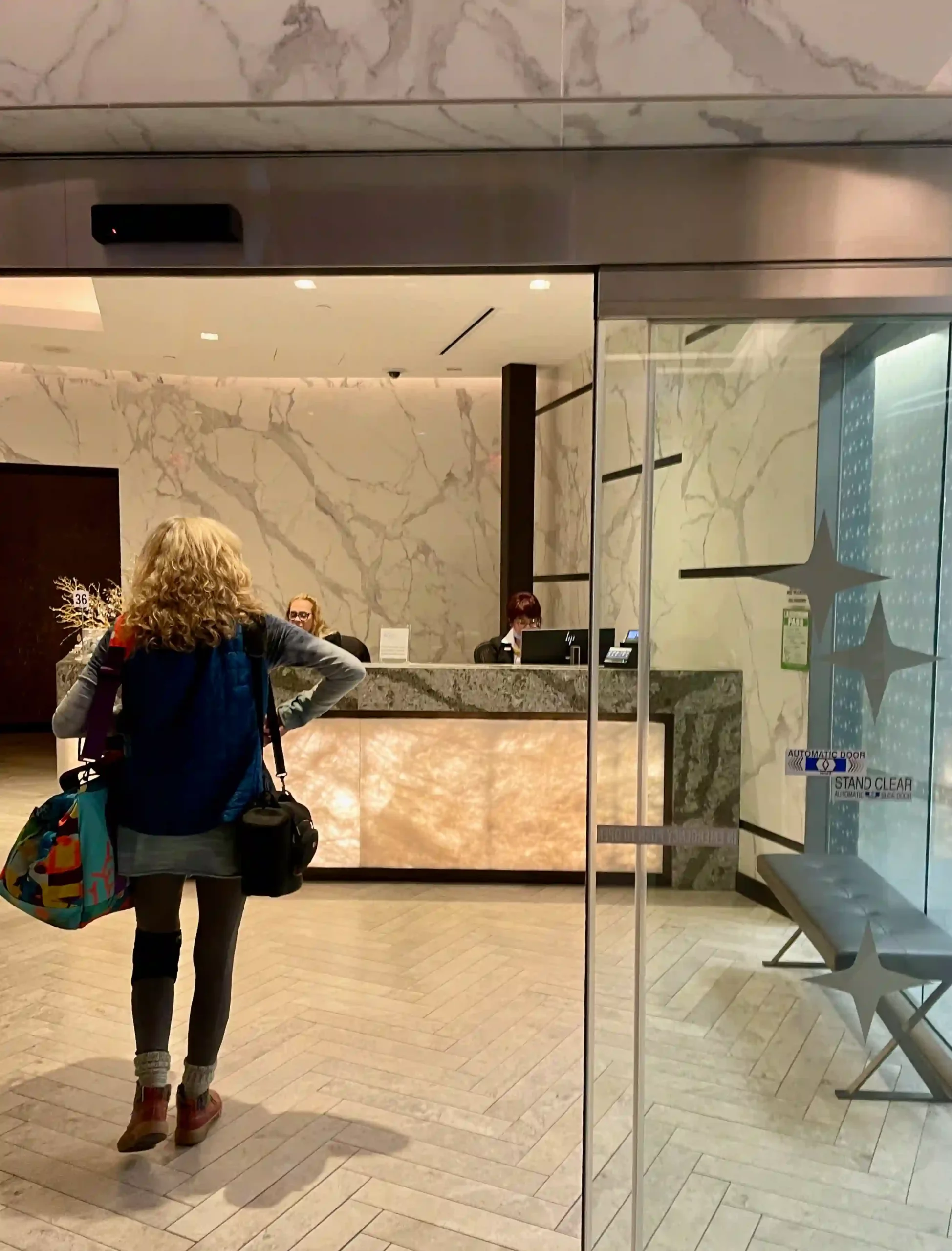 a woman standing in front of a reception desk