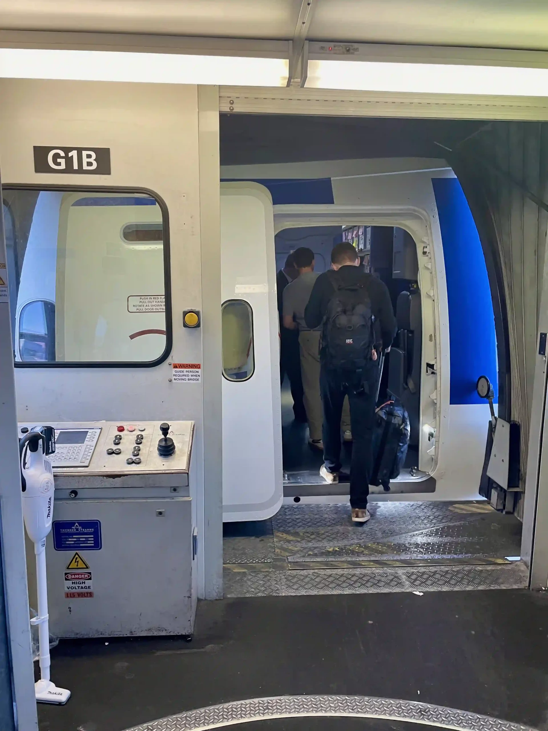 a group of people walking into a train