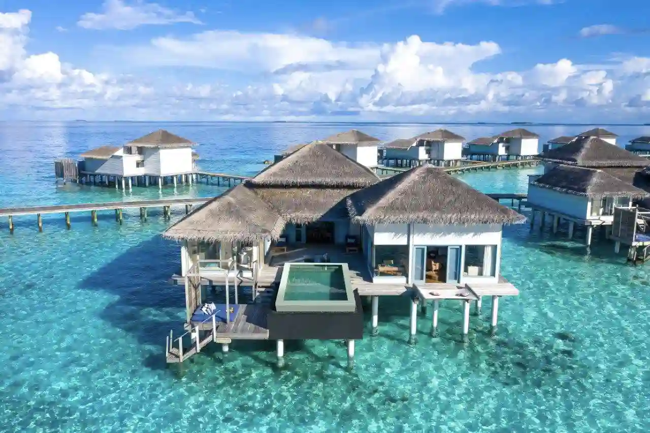 a group of houses on stilts in water