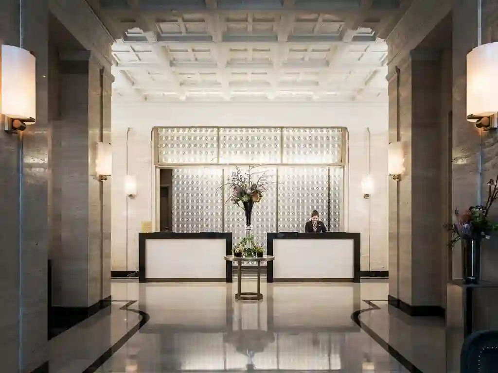 a man standing behind a reception desk