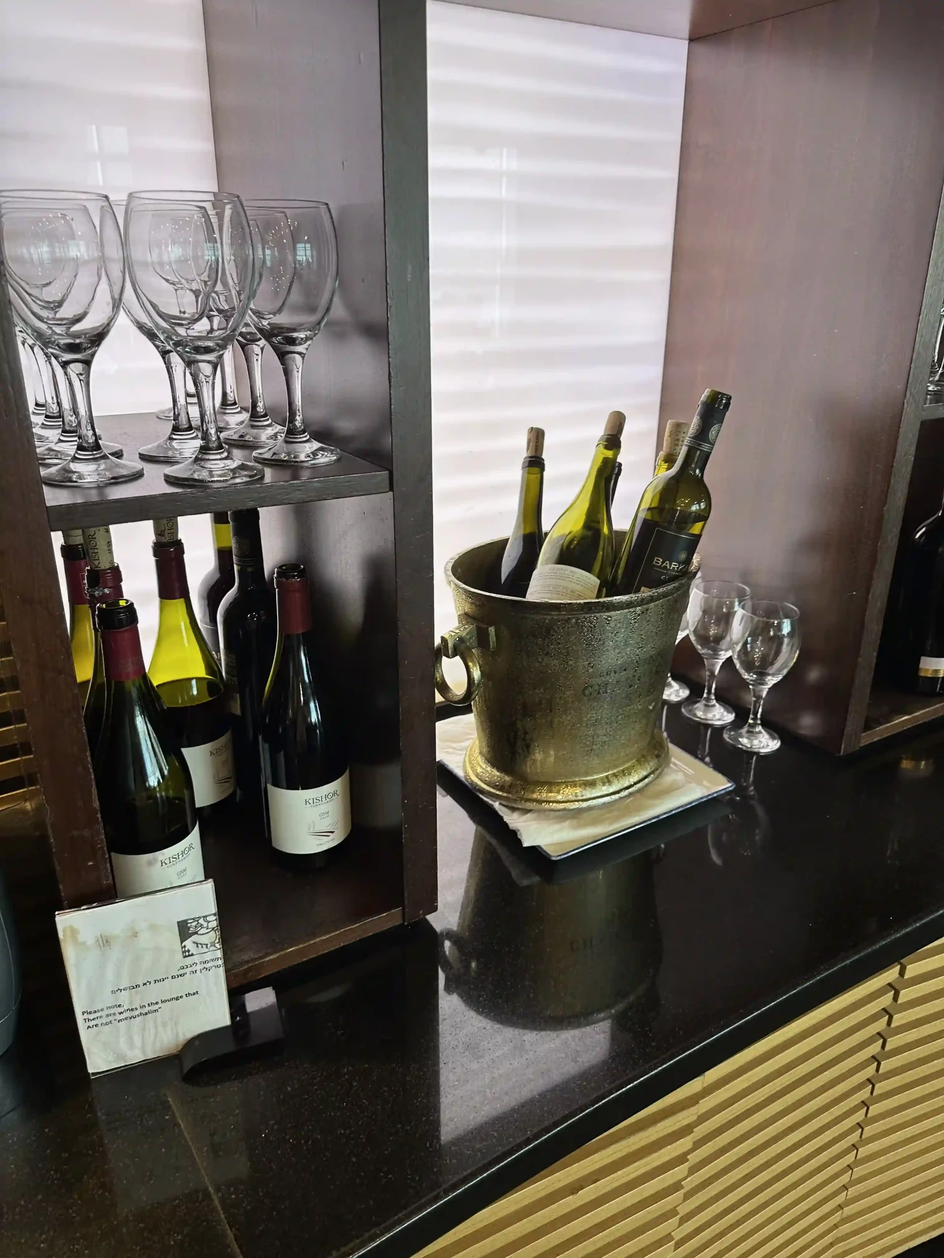 a wine bottles and glasses on a shelf