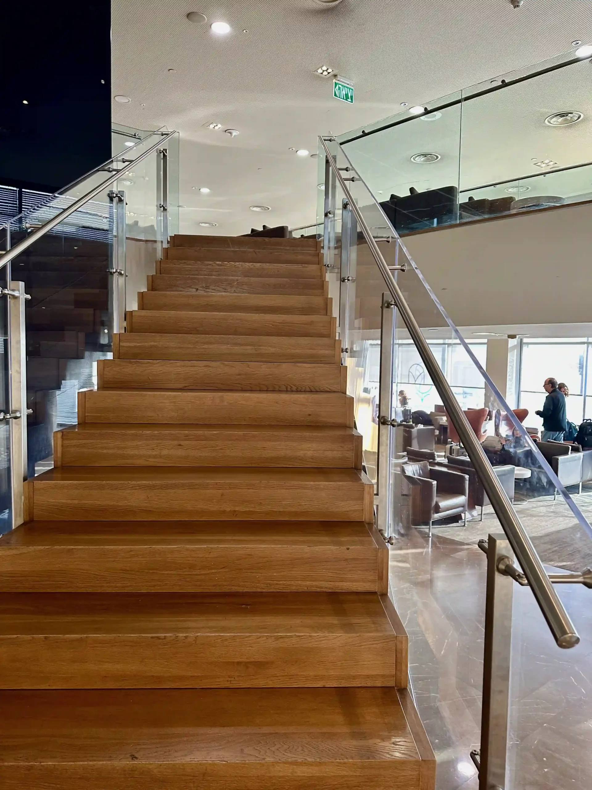 a wooden staircase with glass railings