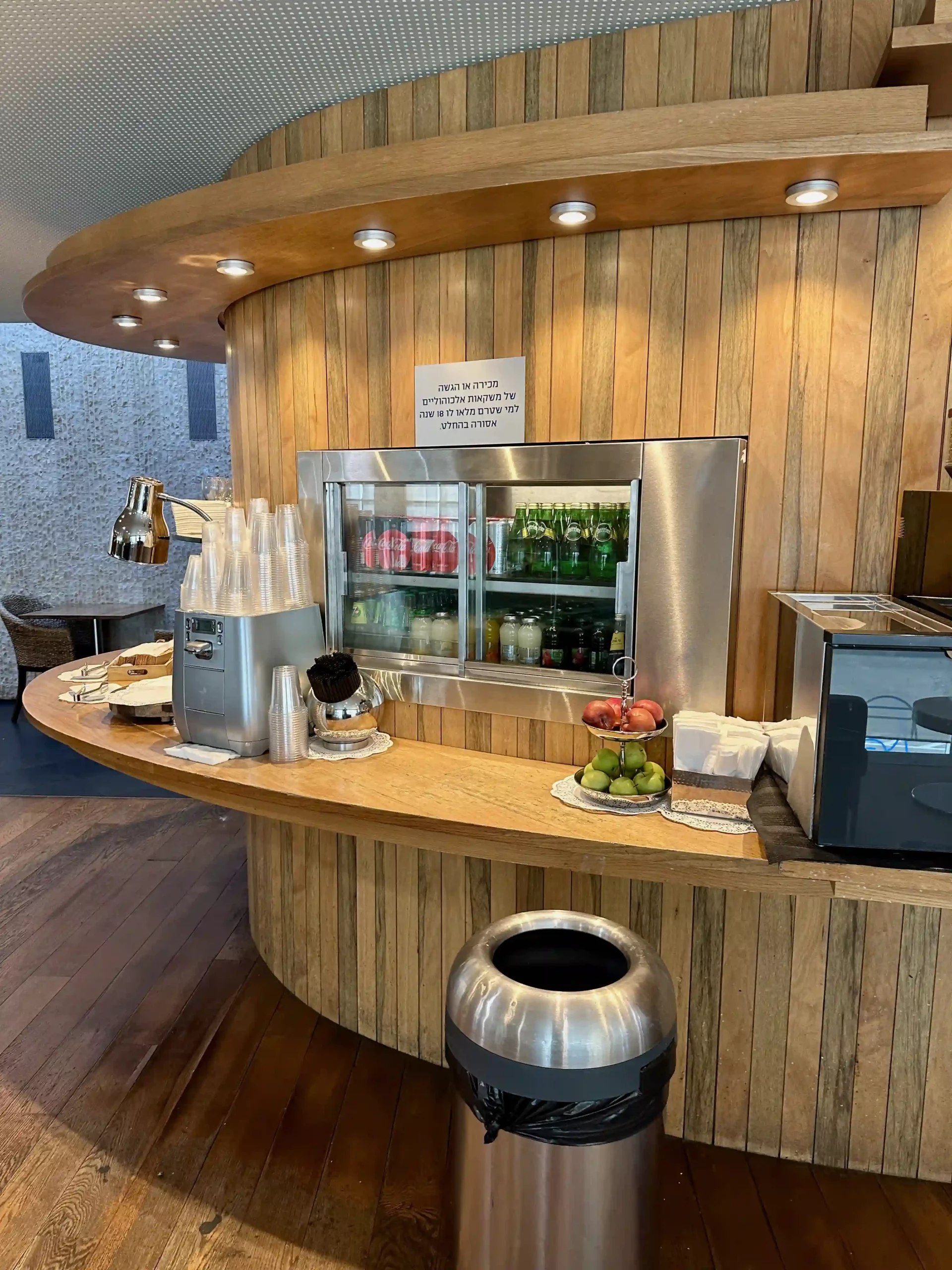 a counter with a beverage cooler and fruit on it