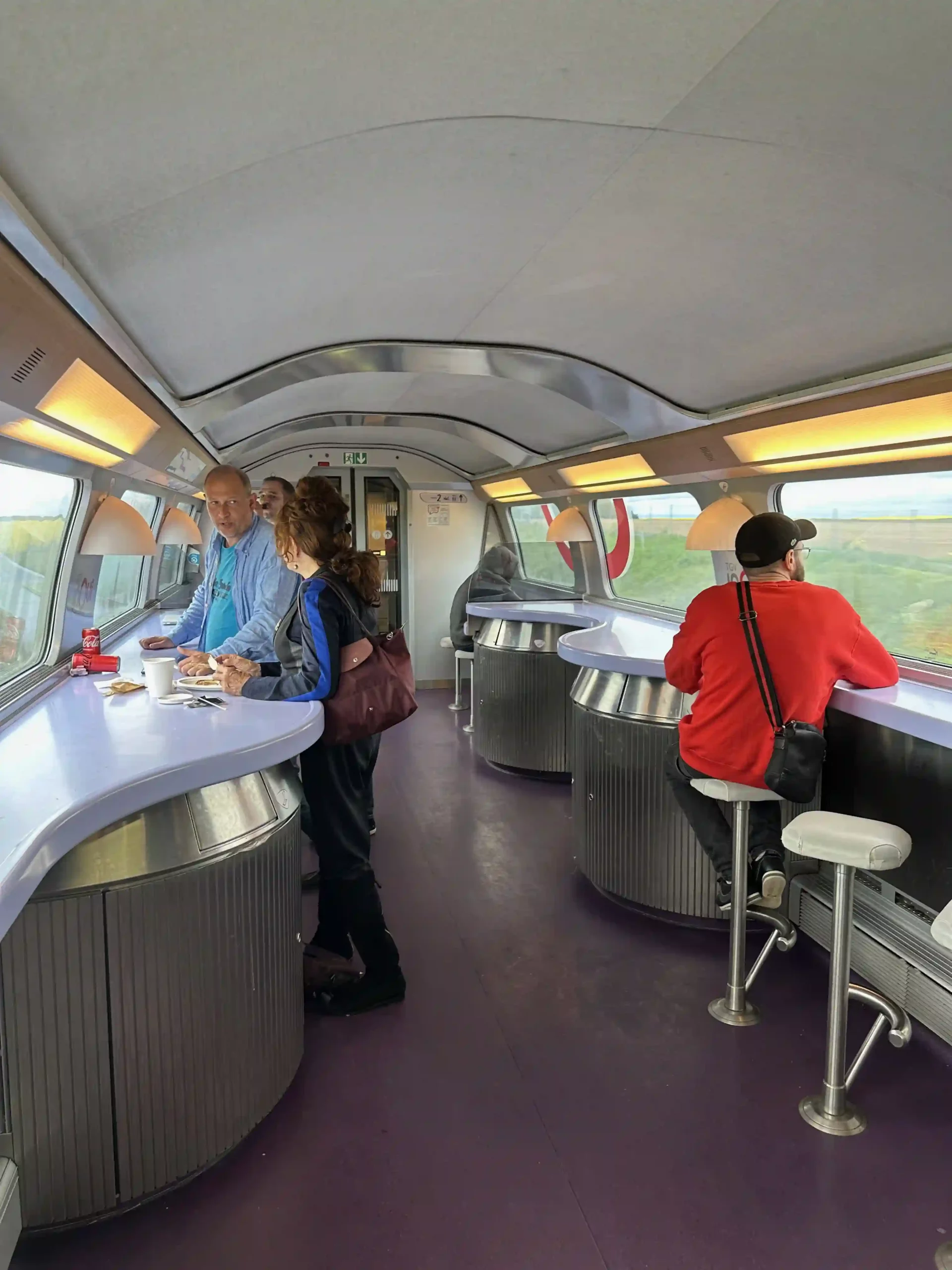 people standing in a room with a counter and people around it