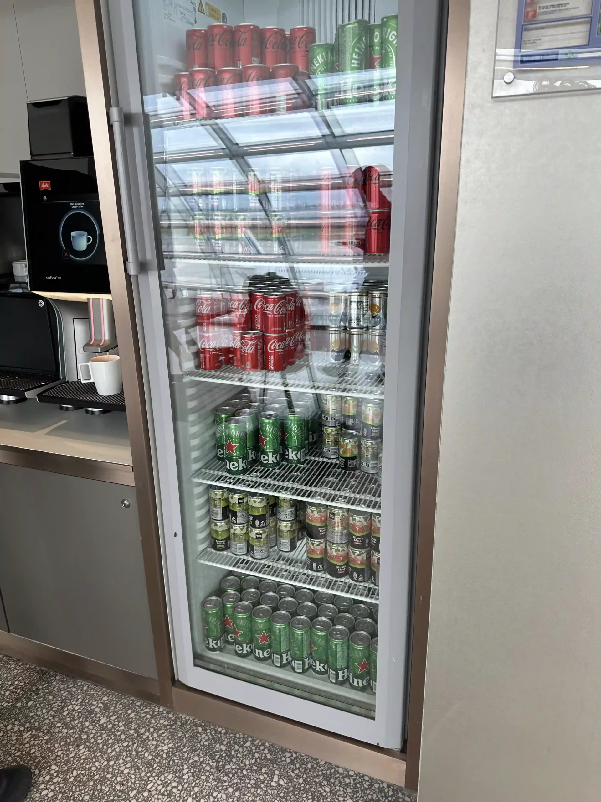 a refrigerator with cans of soda