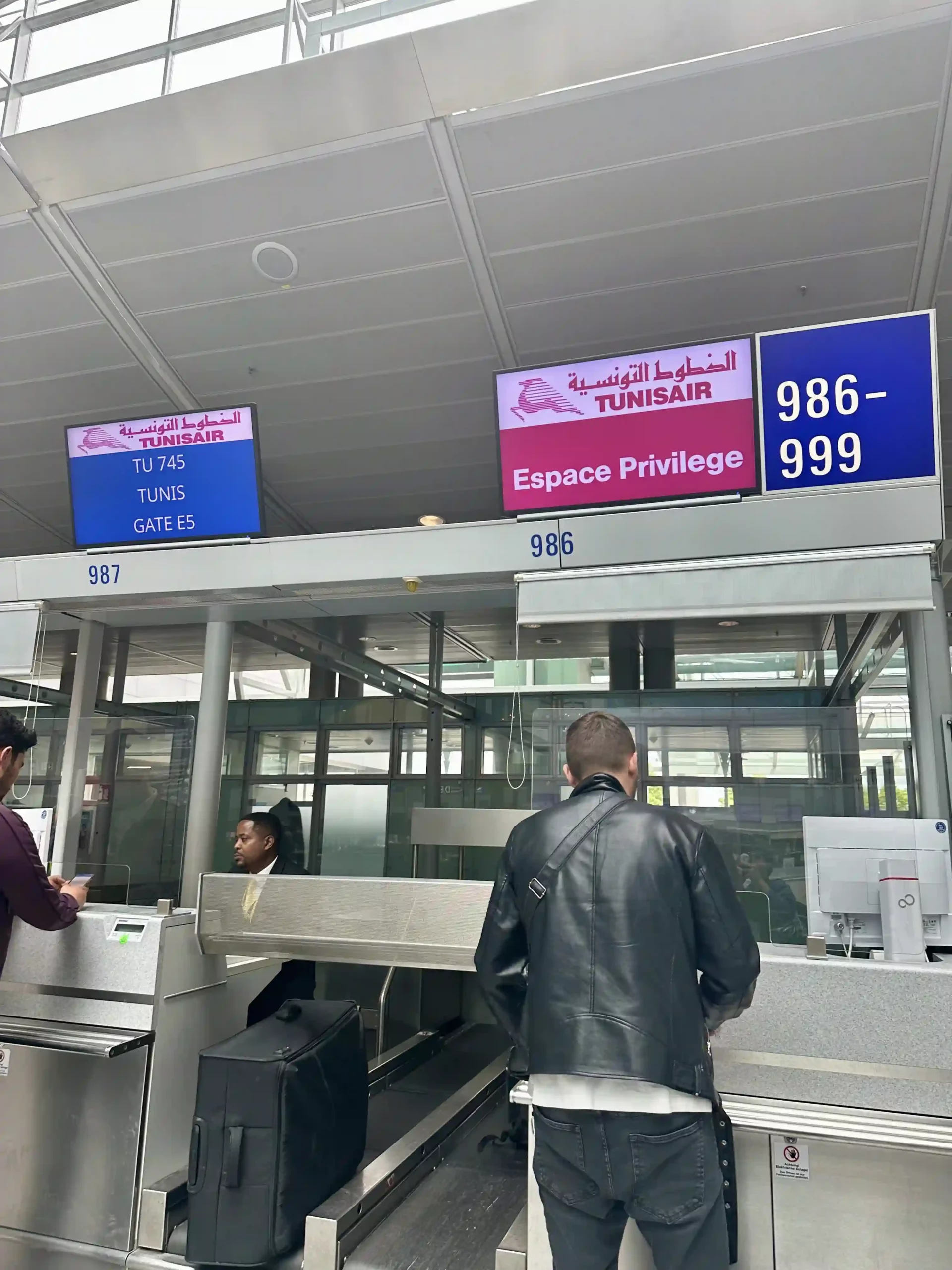 people standing in front of a check in counter