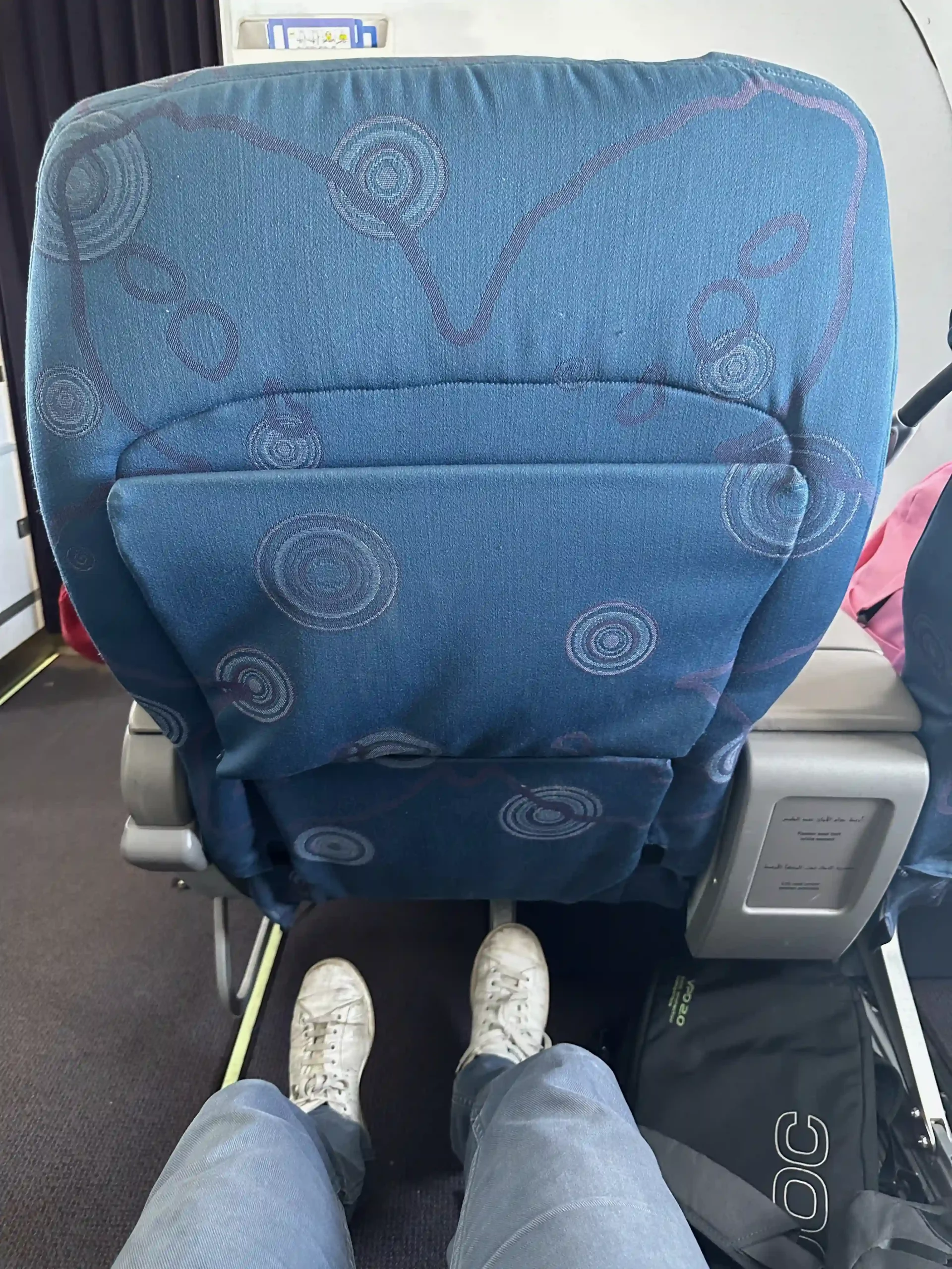 a person's feet in a blue seat