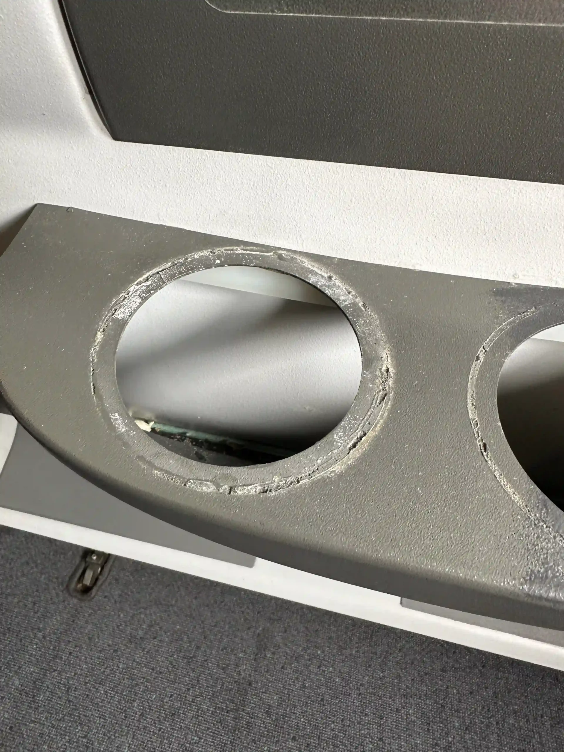 a grey object with holes