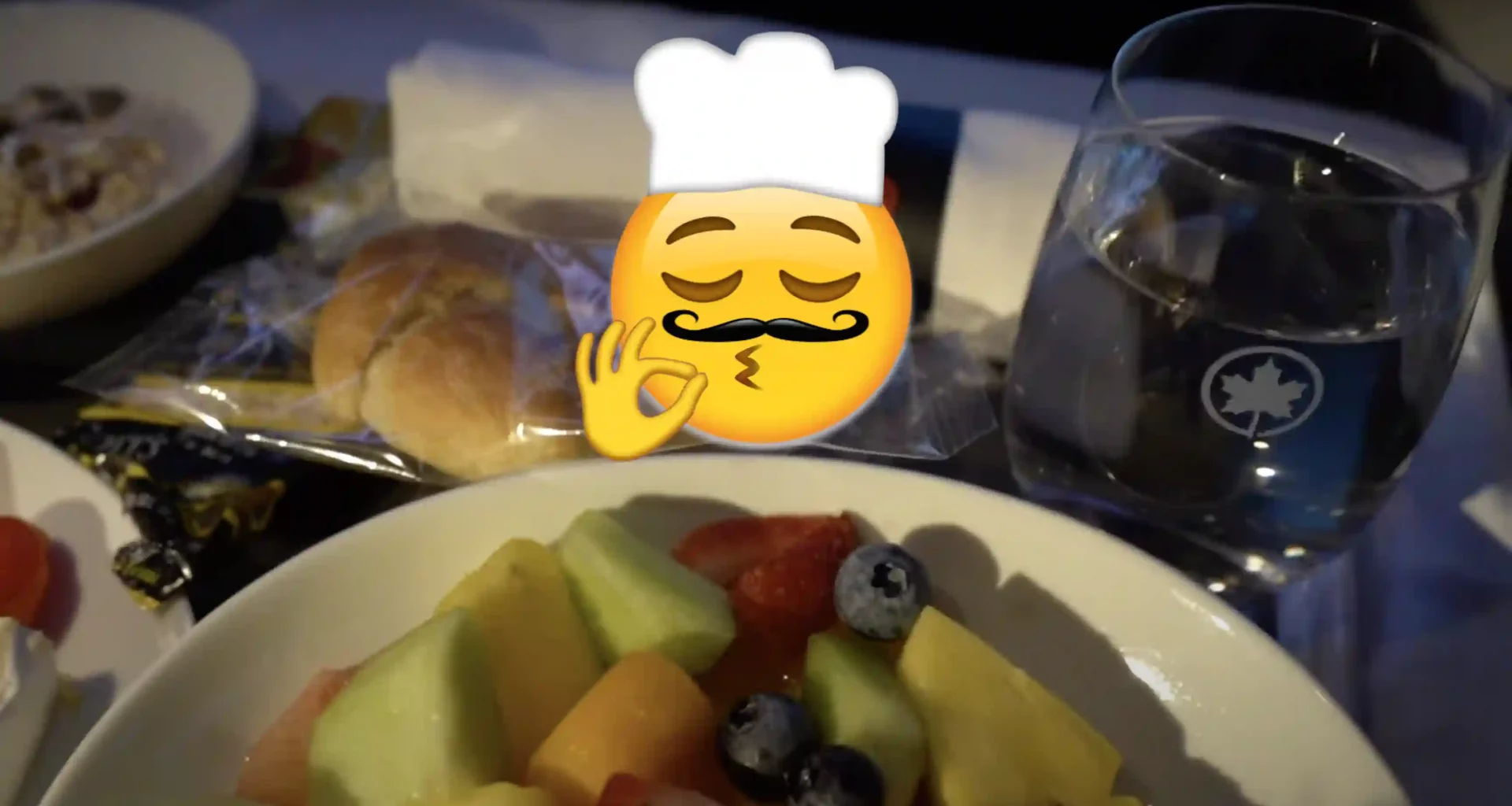 Air Canada business class breakfast with superimposed chef's kiss emoji