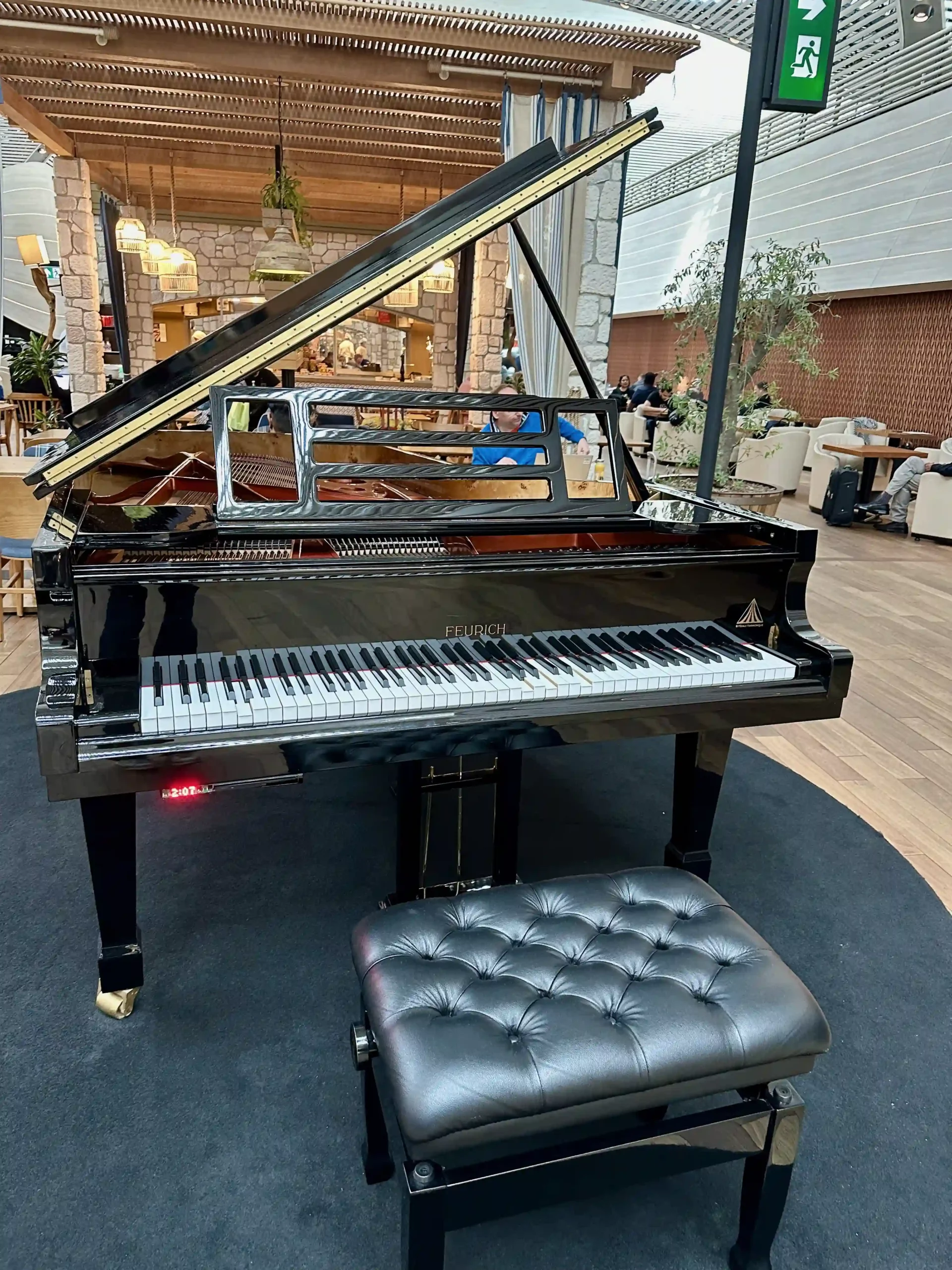 a piano with a stool in a room