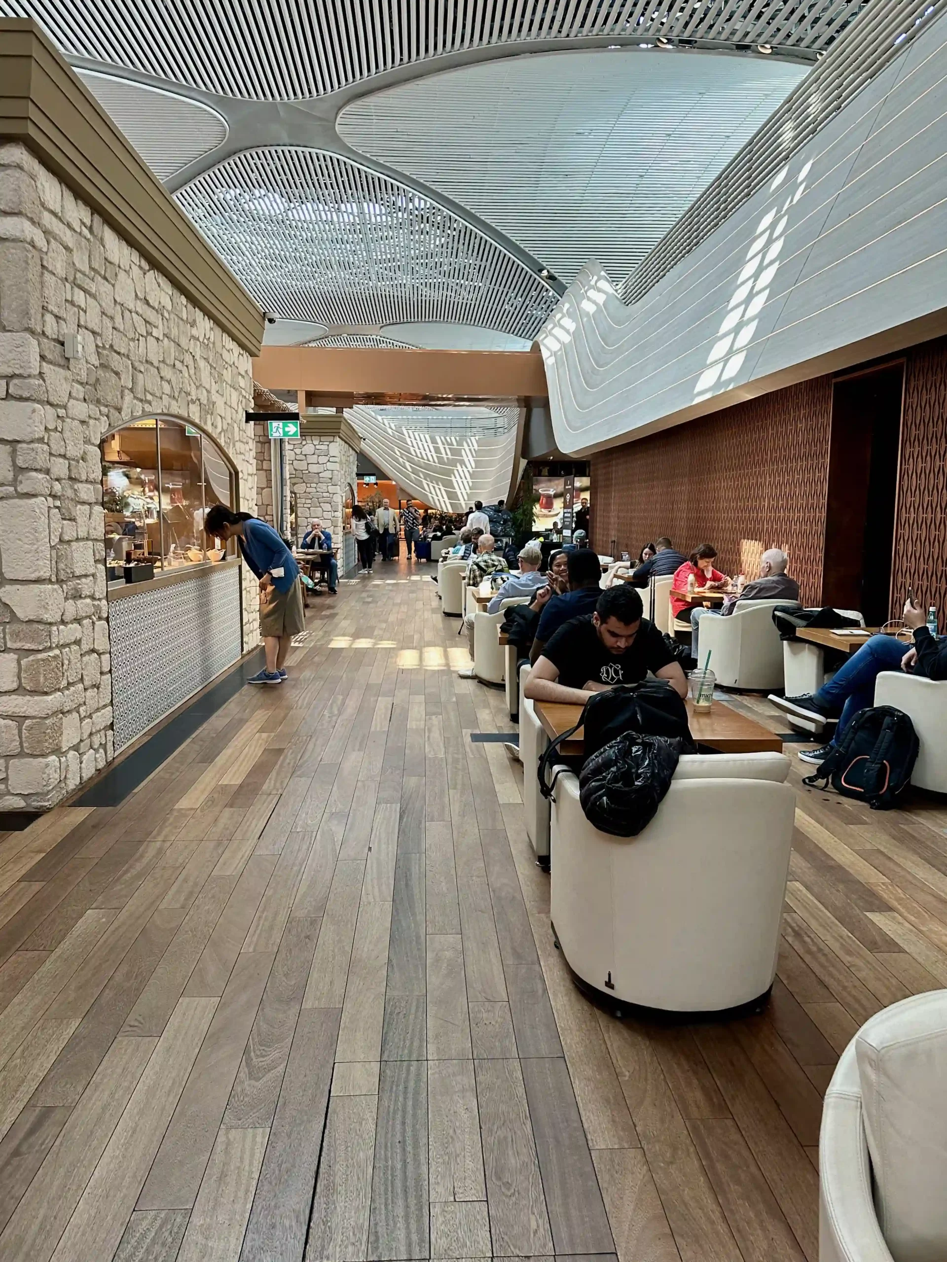 people sitting at tables in a mall