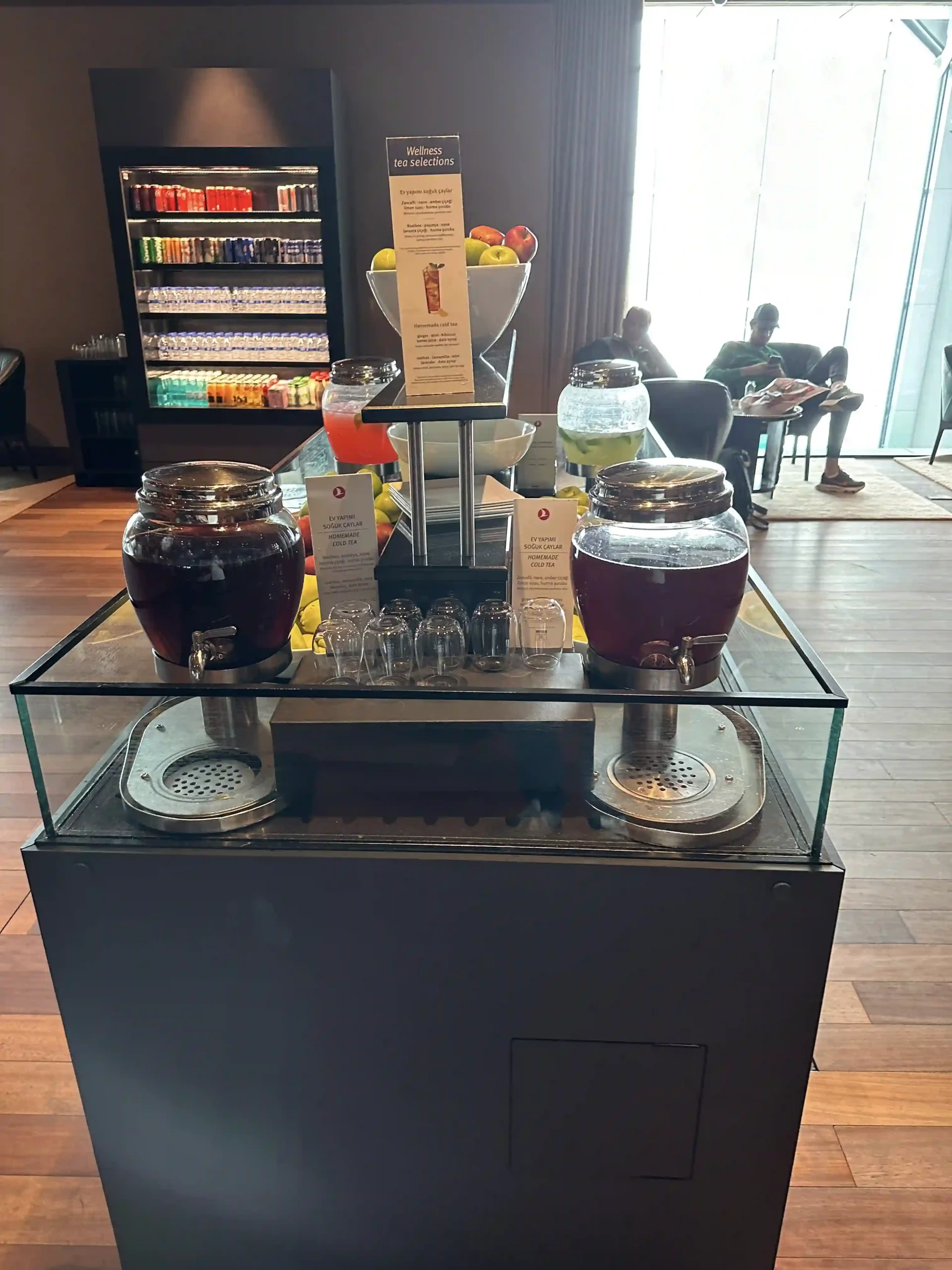a glass display case with drinks on it