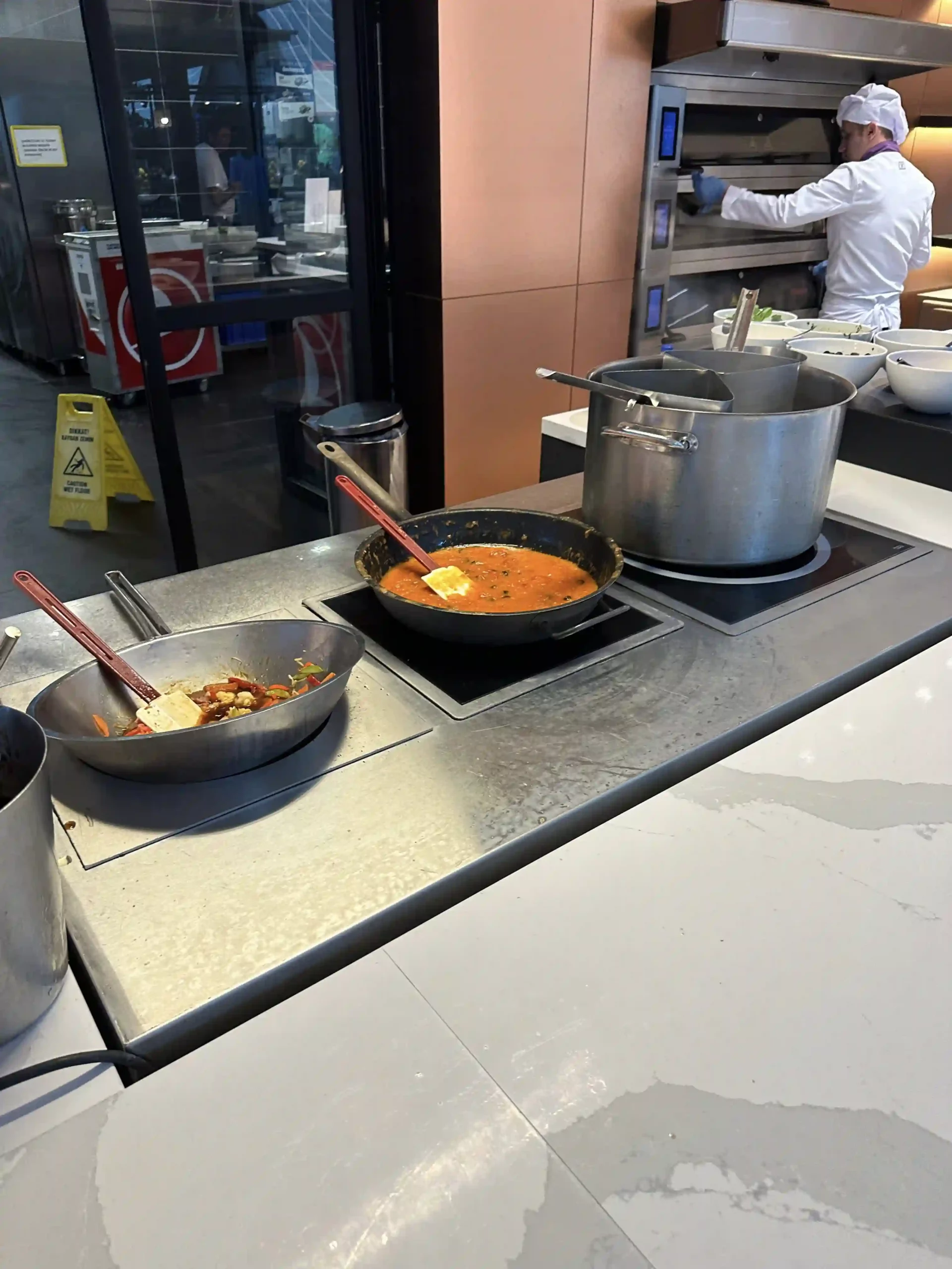 a group of pots with food on a stove