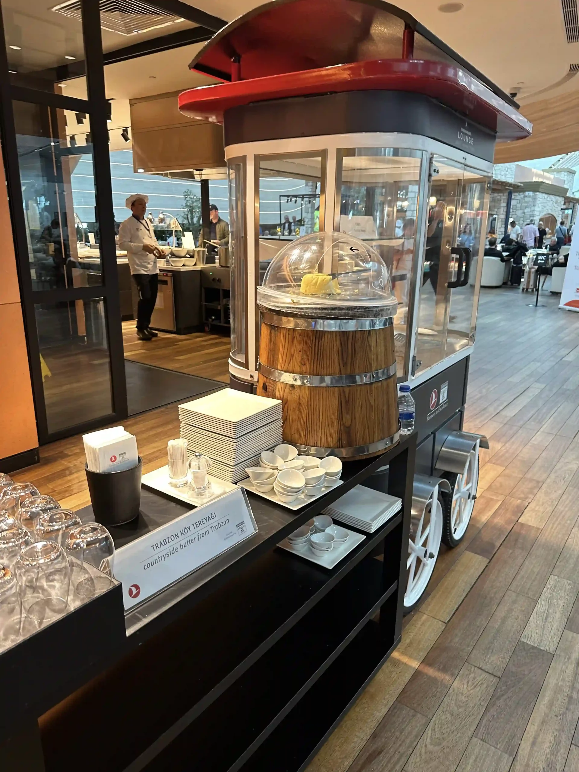 a food cart with a wooden barrel and a glass lid