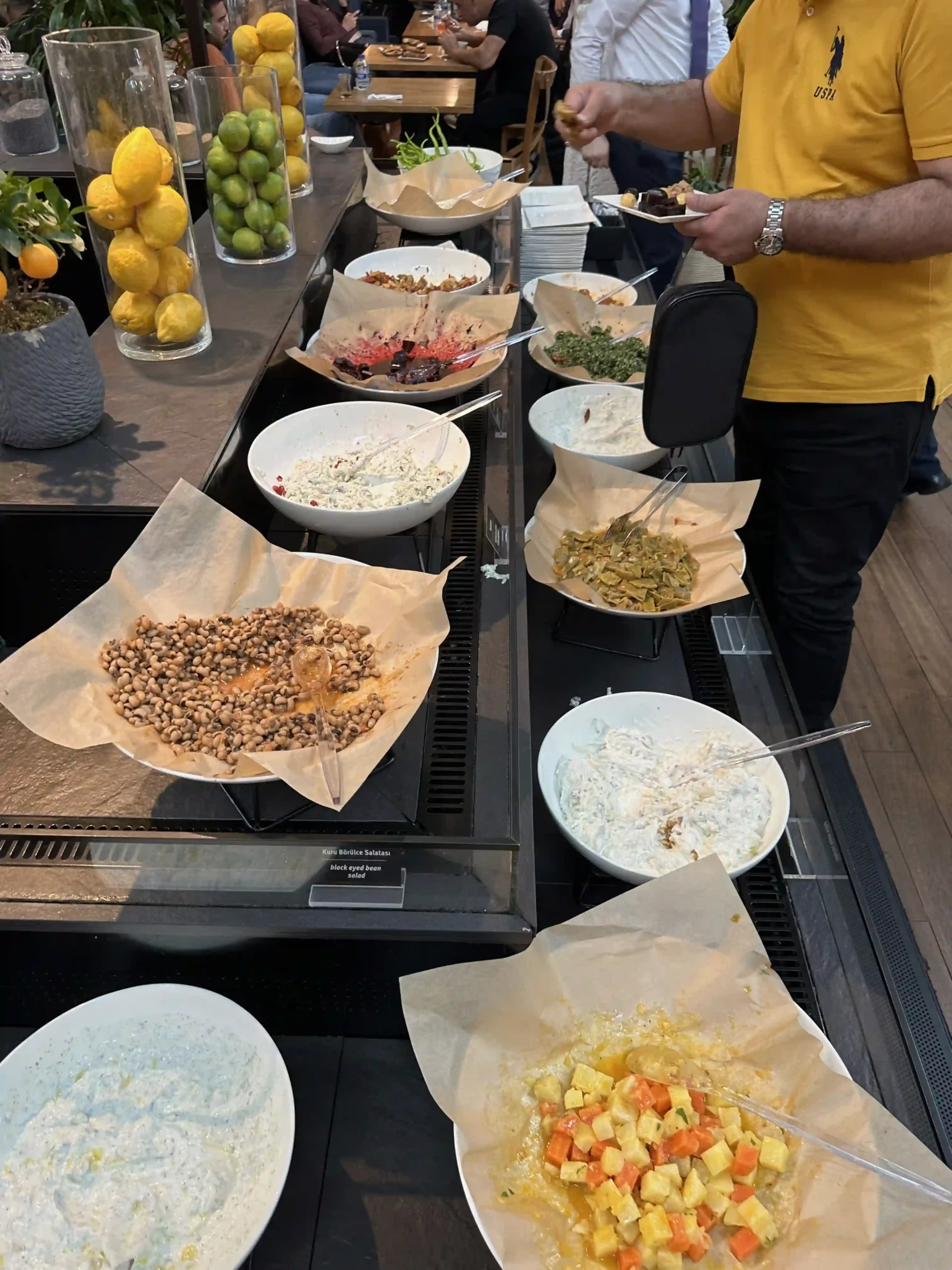 a man standing in front of a buffet table with food