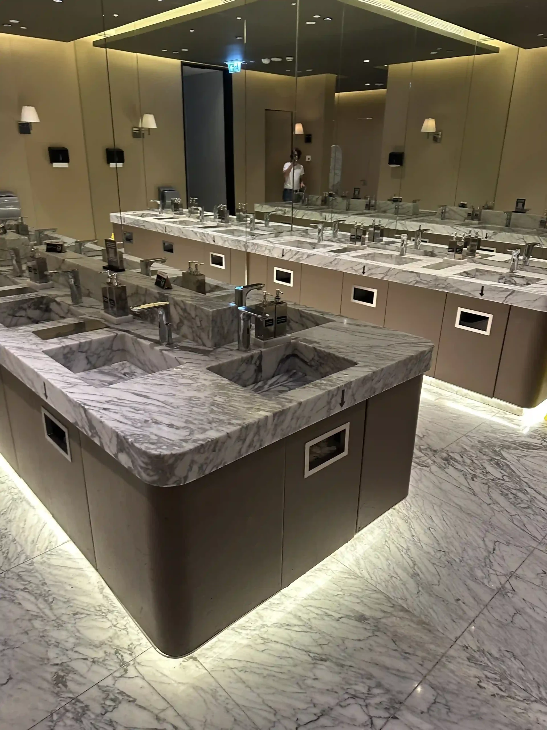 a bathroom with sinks and mirrors