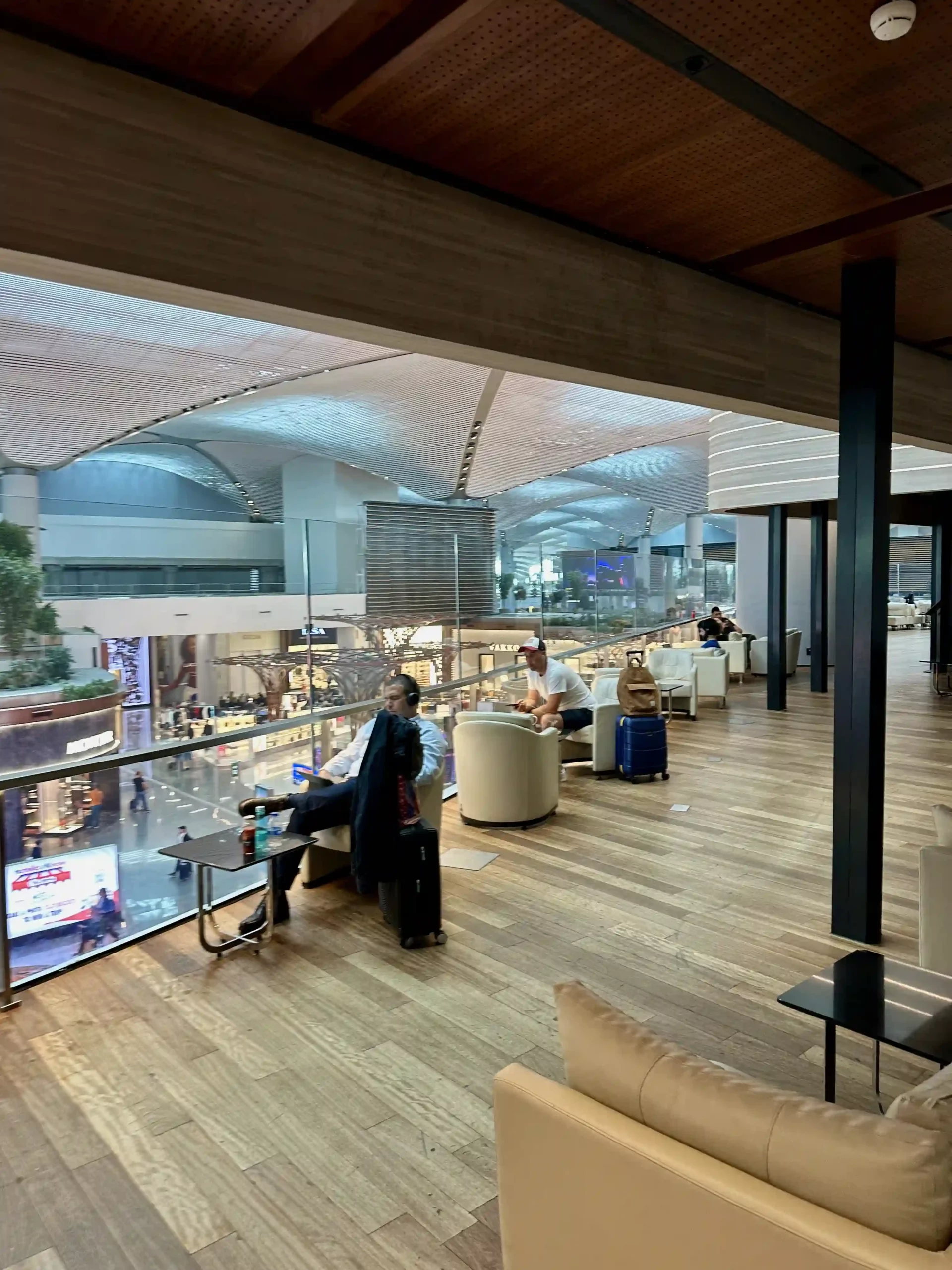 people sitting in a room with a glass wall and a window