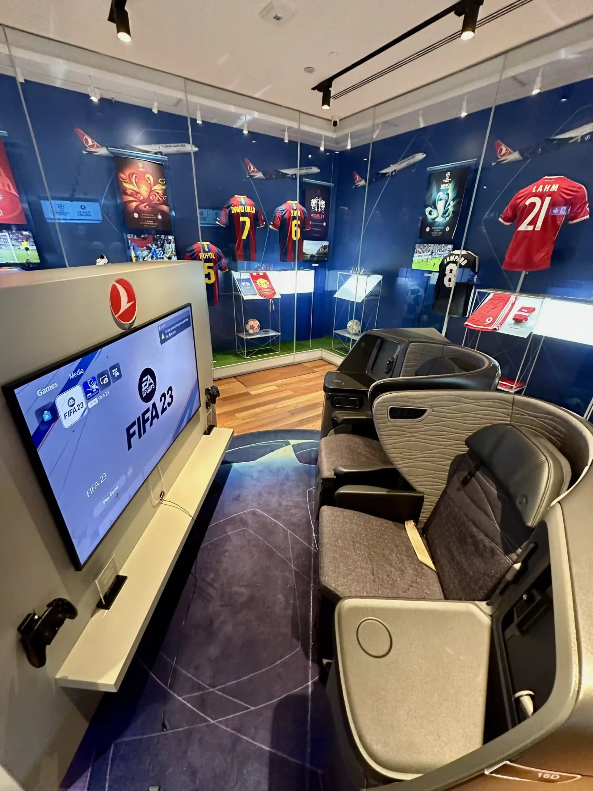 a room with a television and sports uniforms