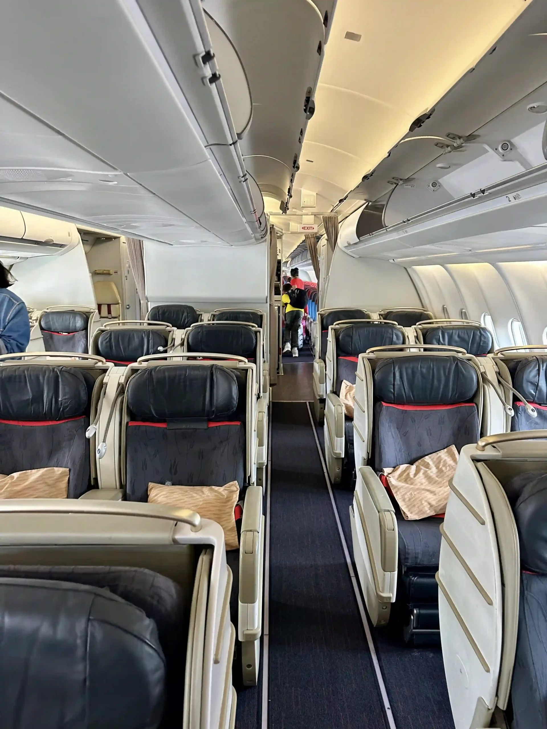 a plane with seats and people in the background
