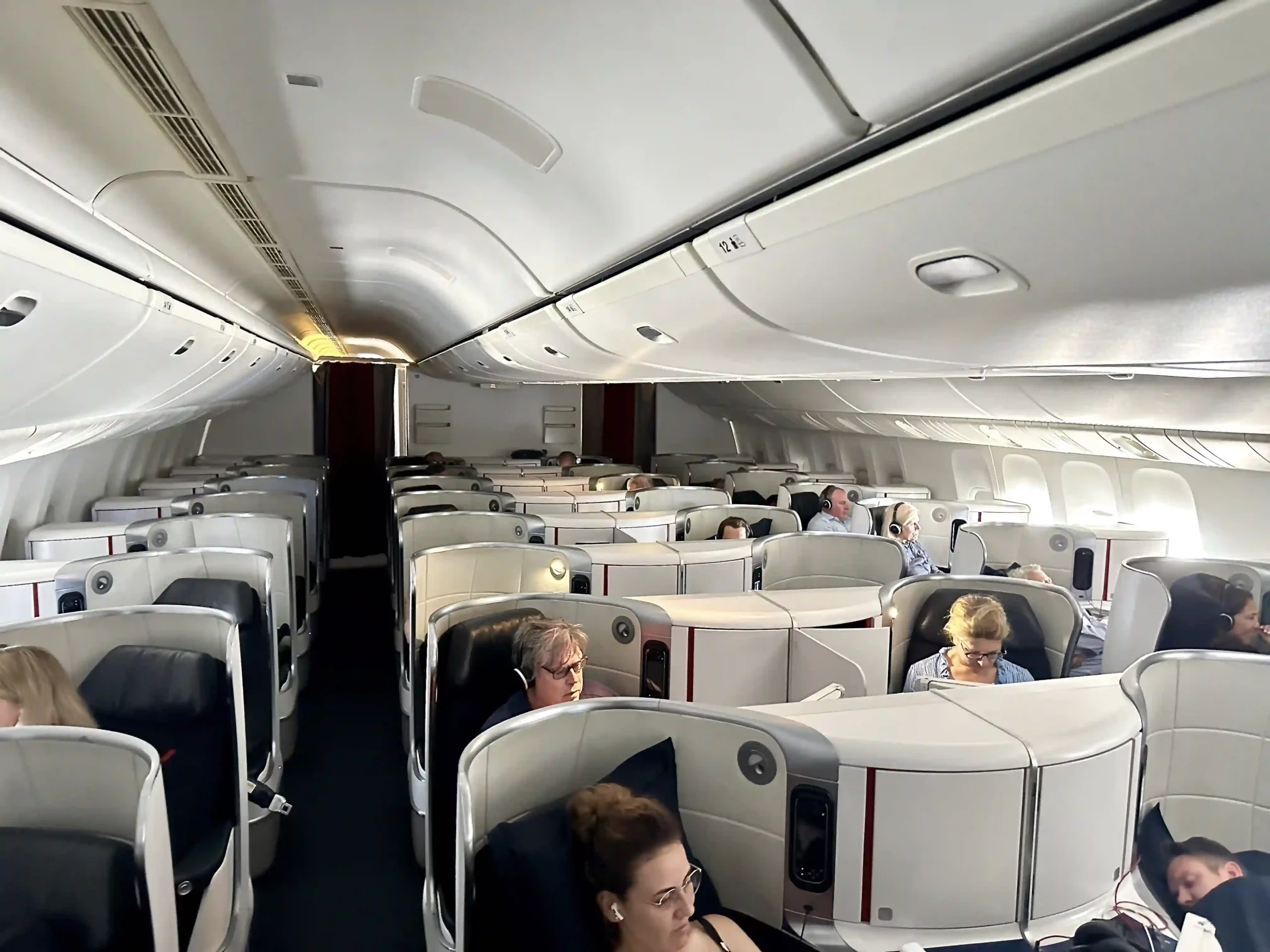 a group of people sitting in chairs on an airplane