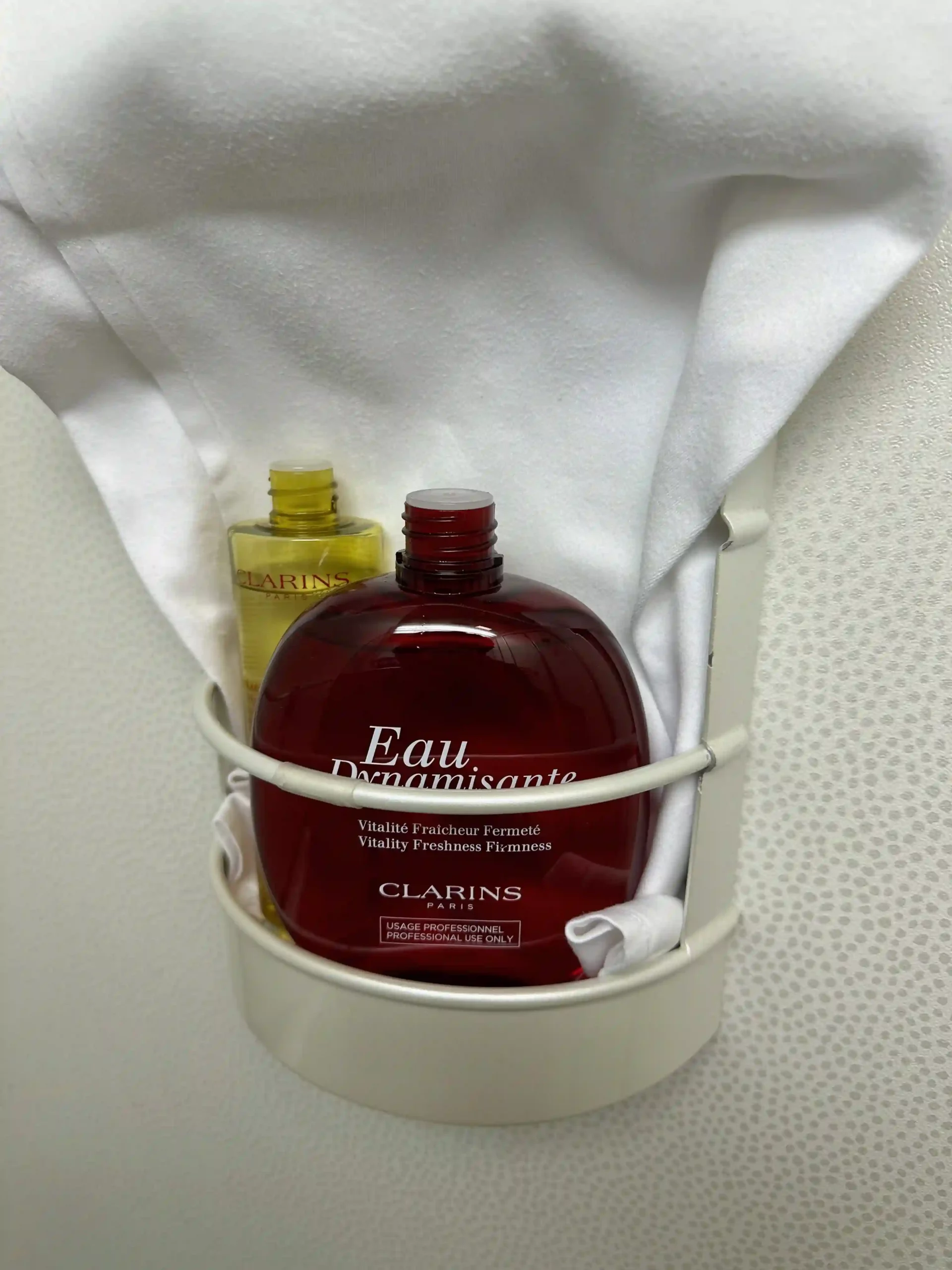 a bottle of lotion in a white basket
