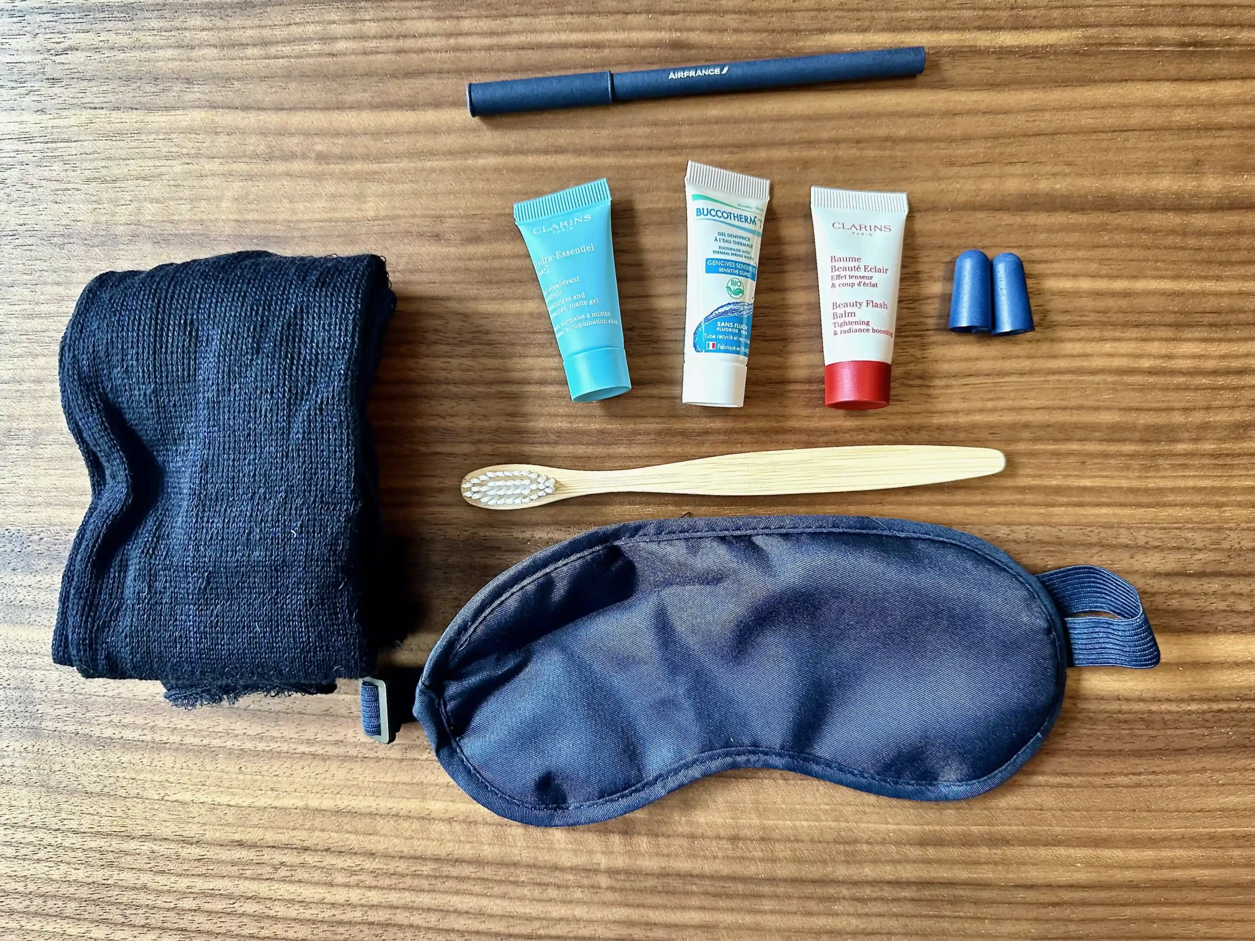 a sleeping mask and toothbrushes on a table