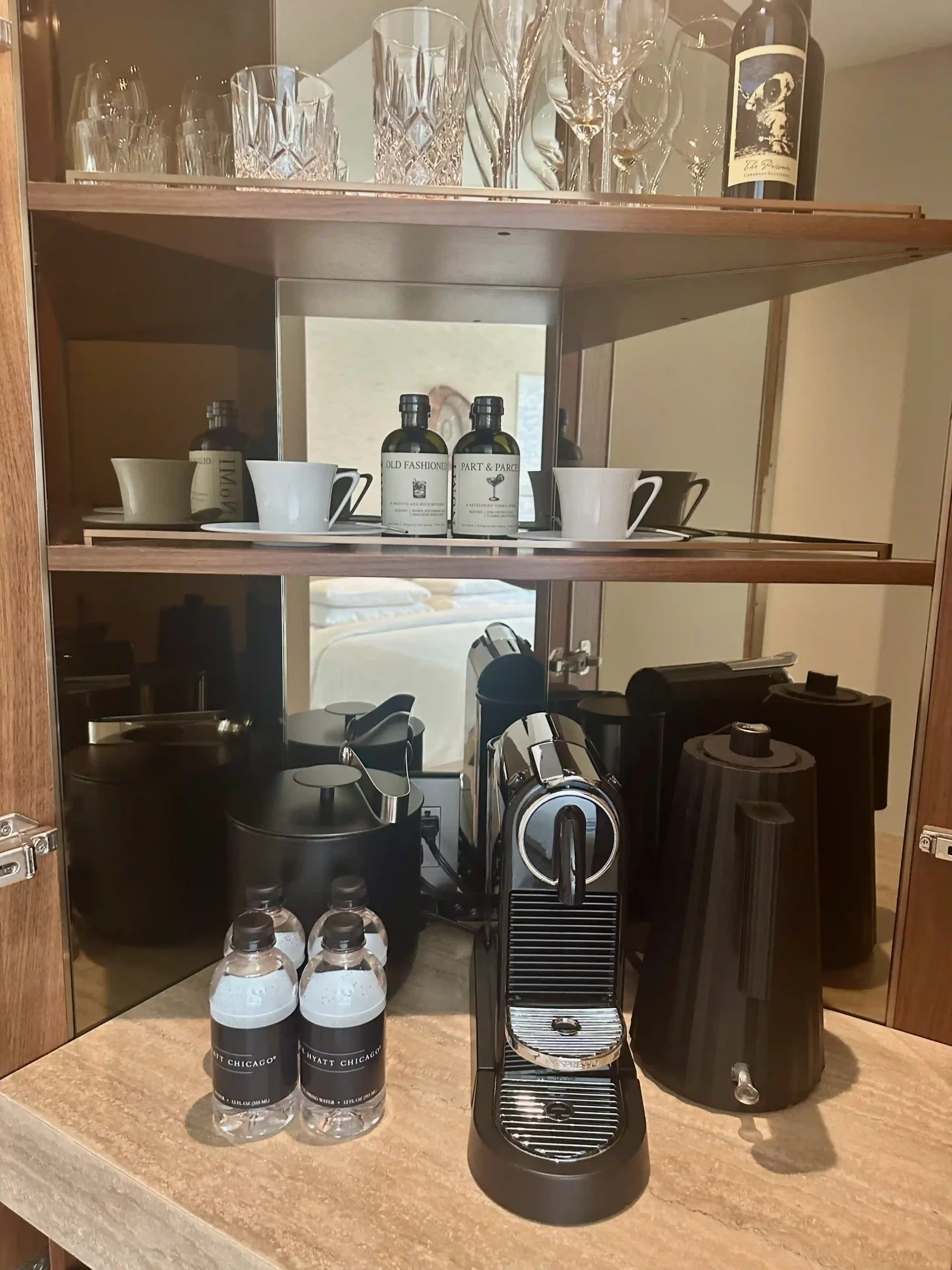 a shelf with coffee machine and cups on it