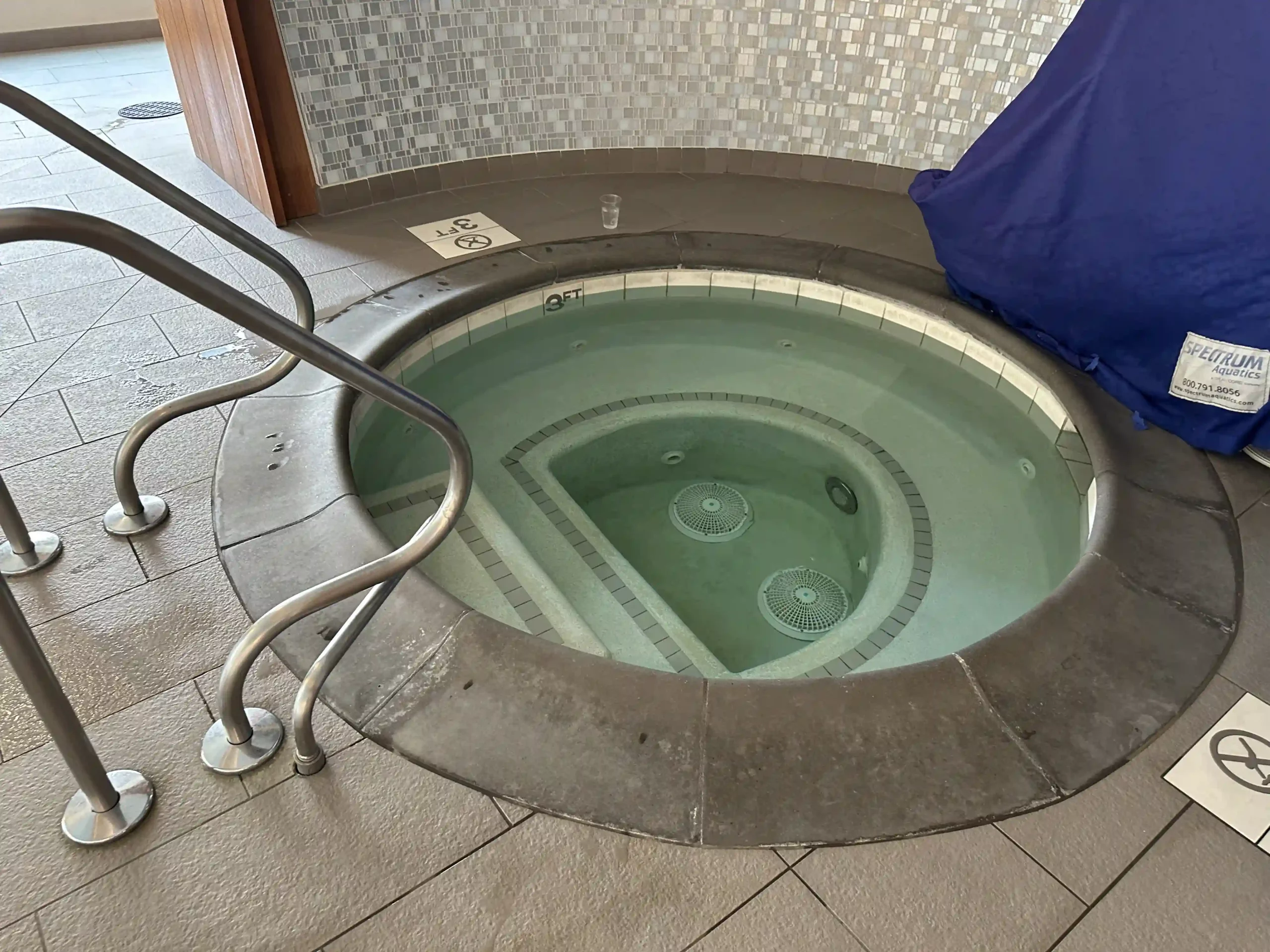 a hot tub with a metal railing