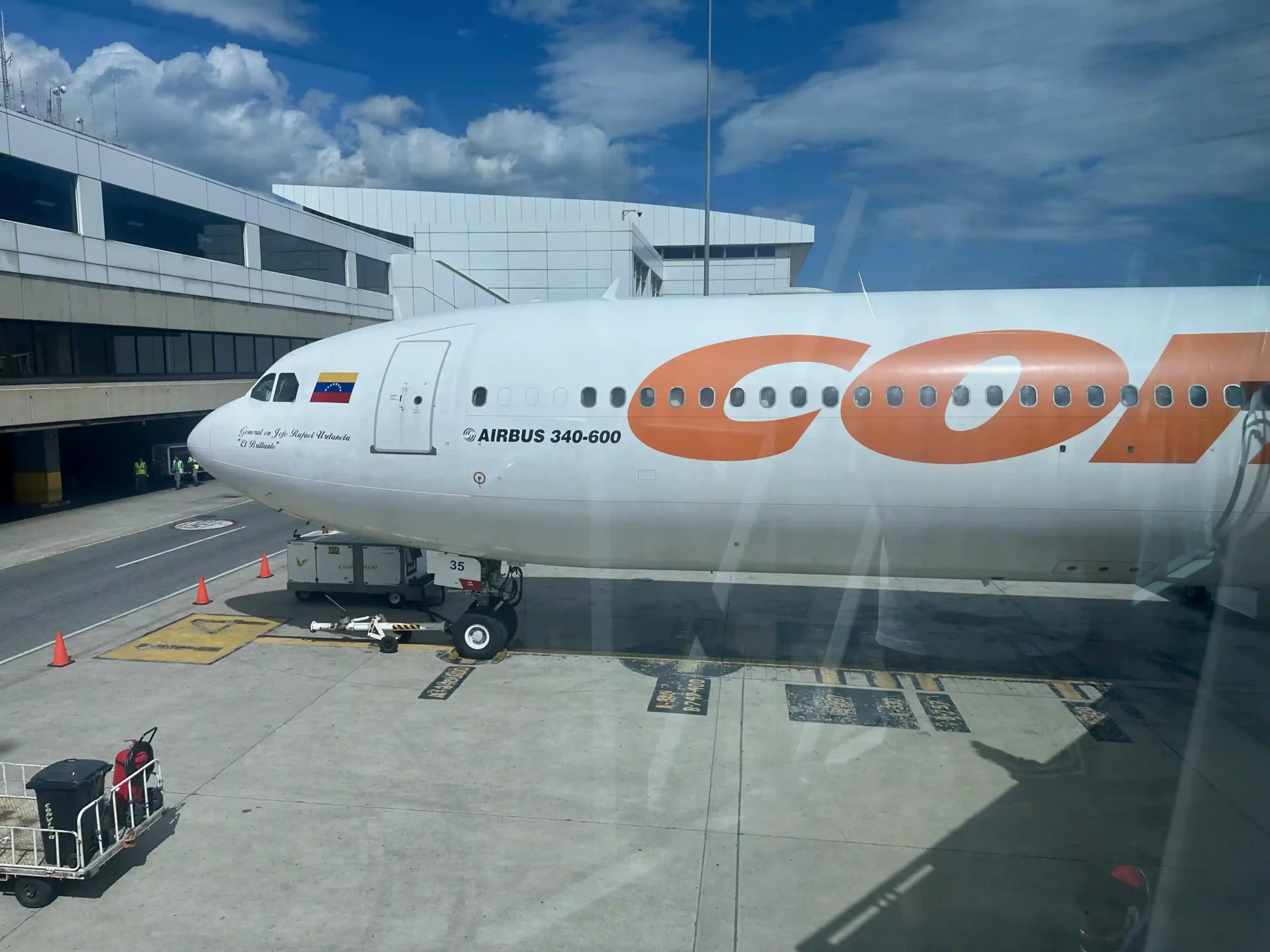a large white airplane with orange and white logo