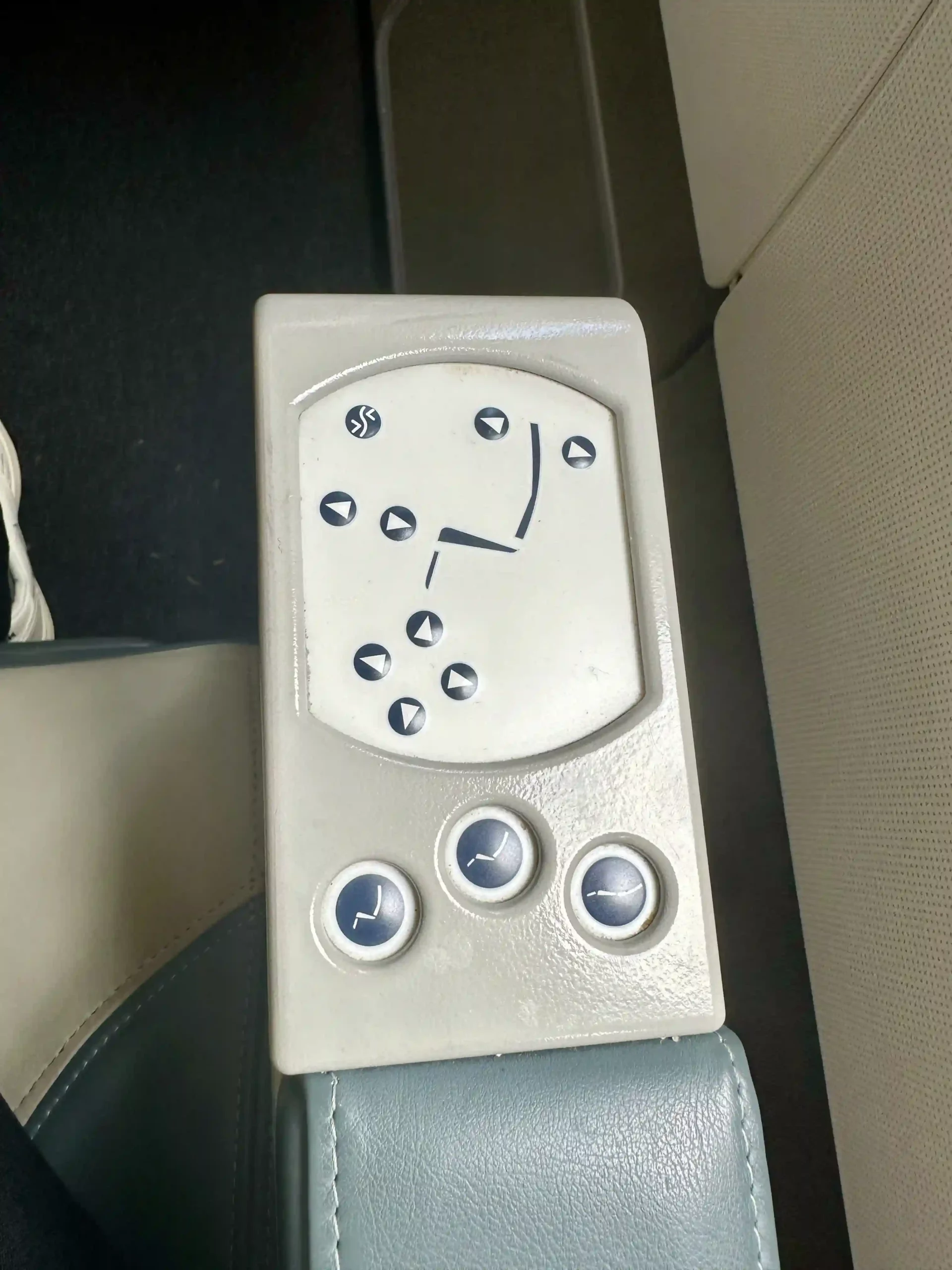 a white rectangular object with buttons and arrows