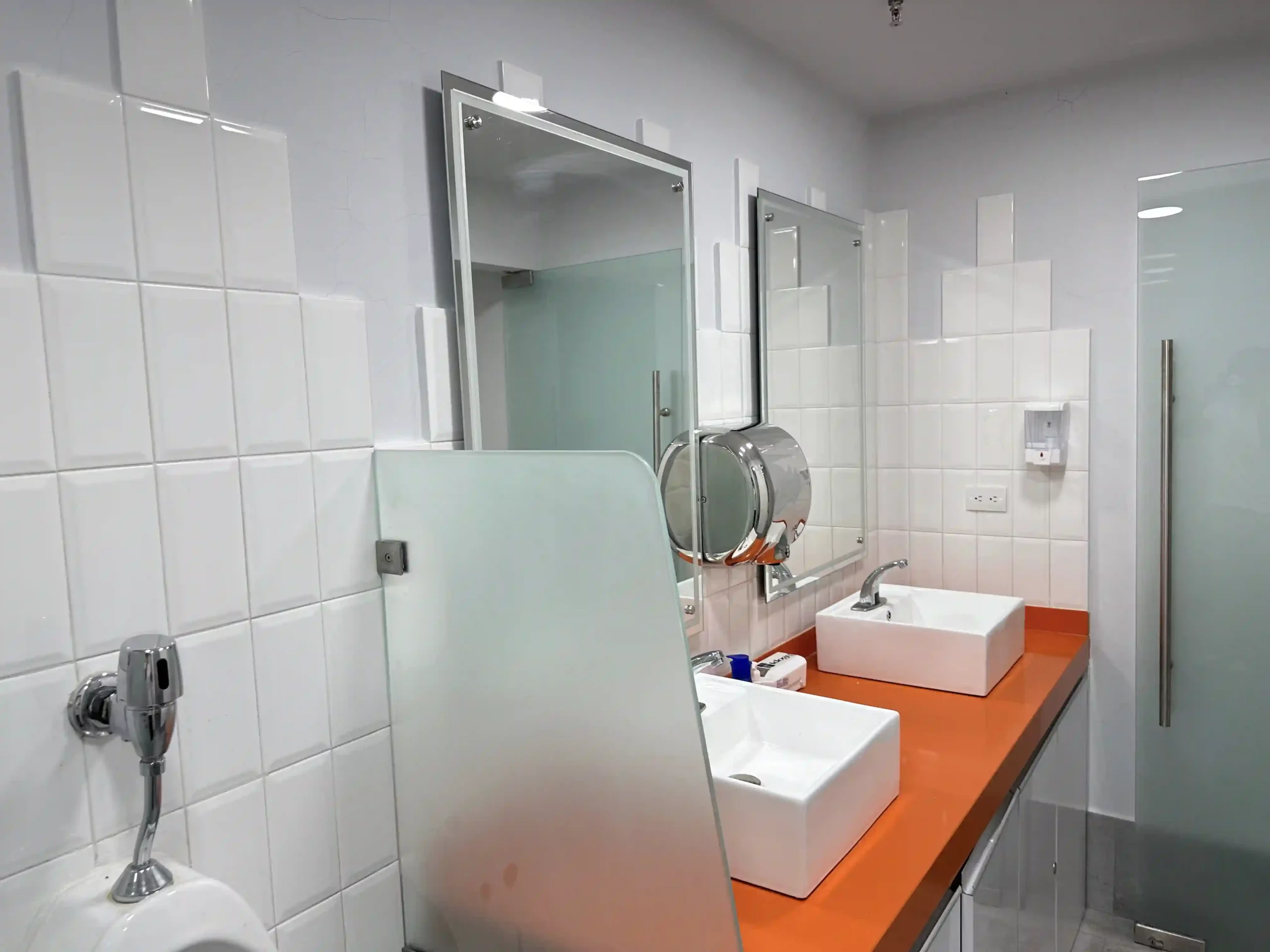 a bathroom with sinks and mirrors