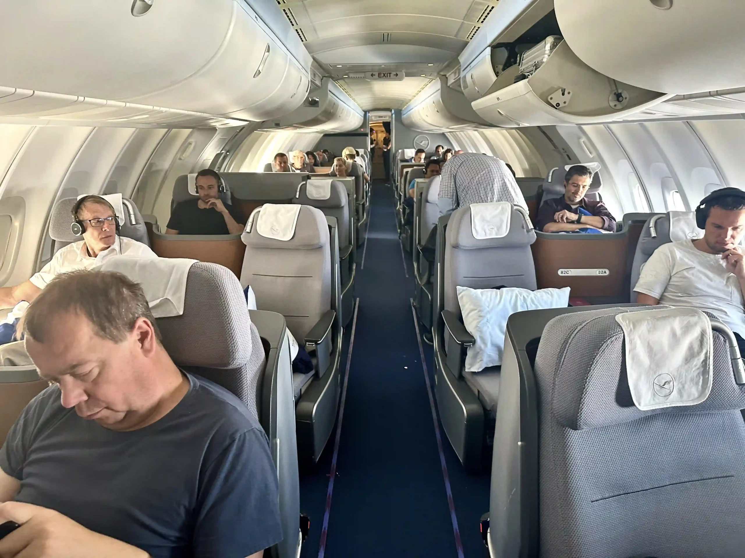 a group of people sleeping on an airplane