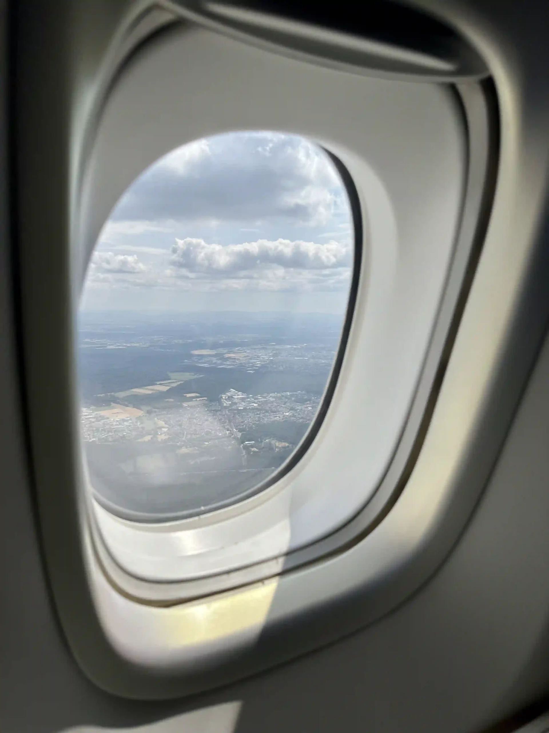 an airplane window with a view of the city