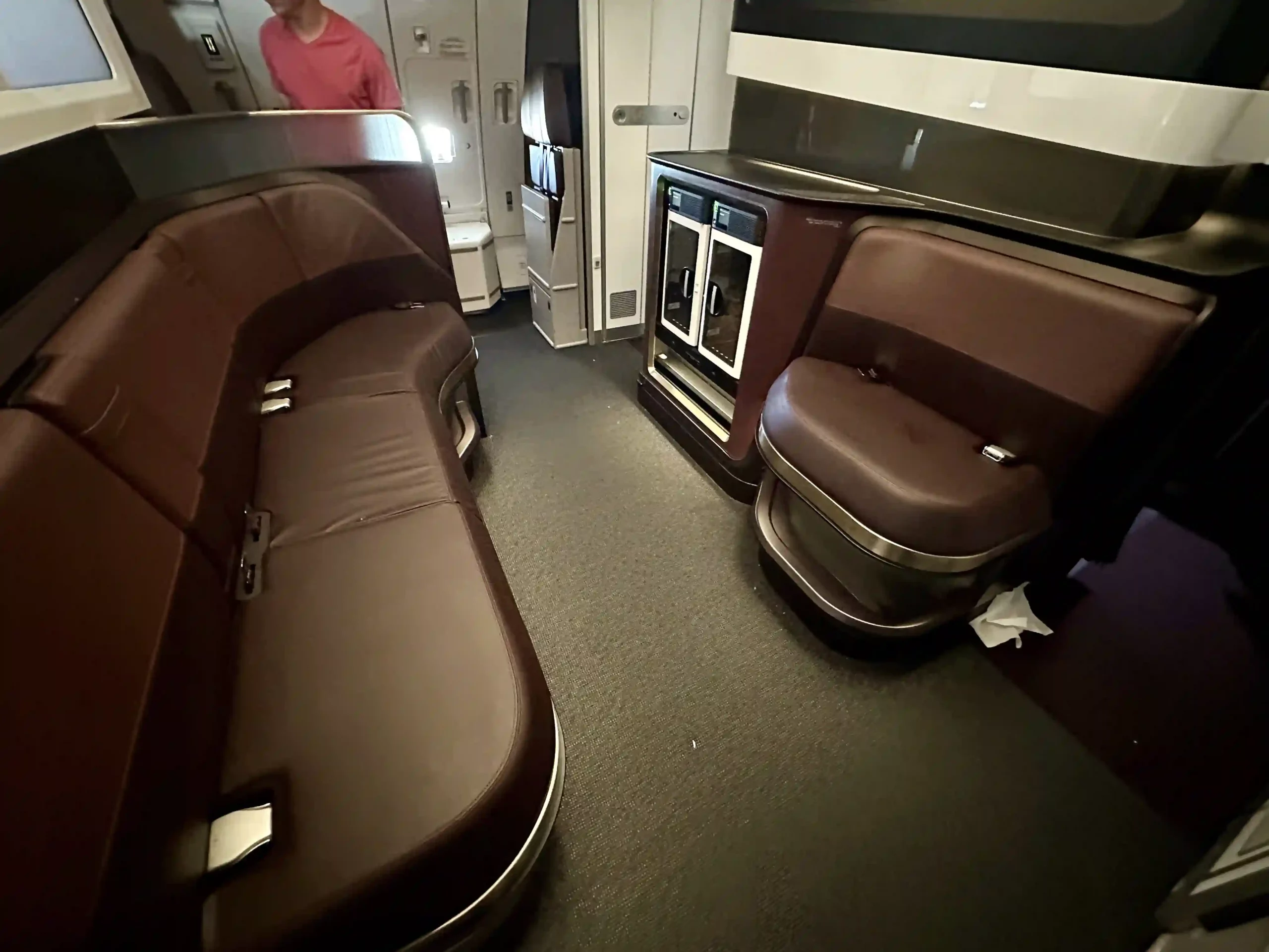 a man standing in a room with brown leather seats