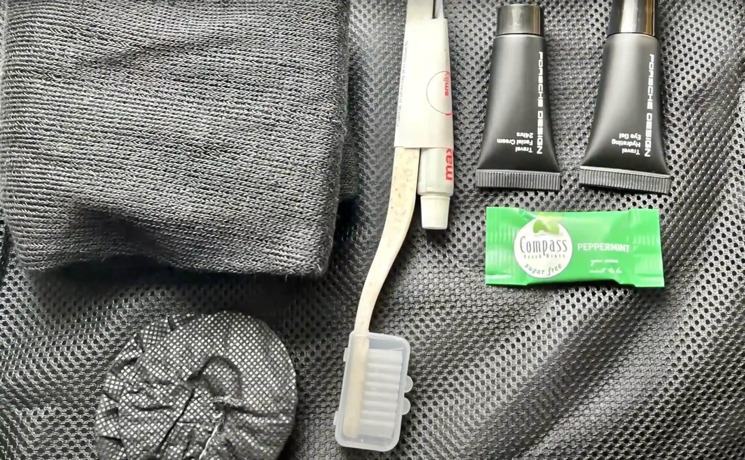 a toothbrush and toothpaste next to a towel