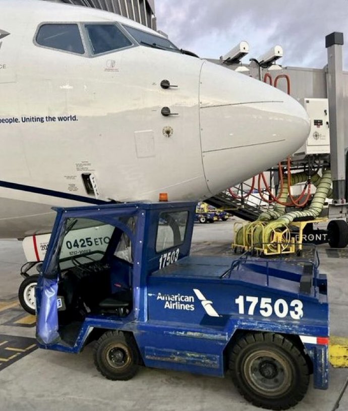 a blue vehicle with a large white airplane in the front