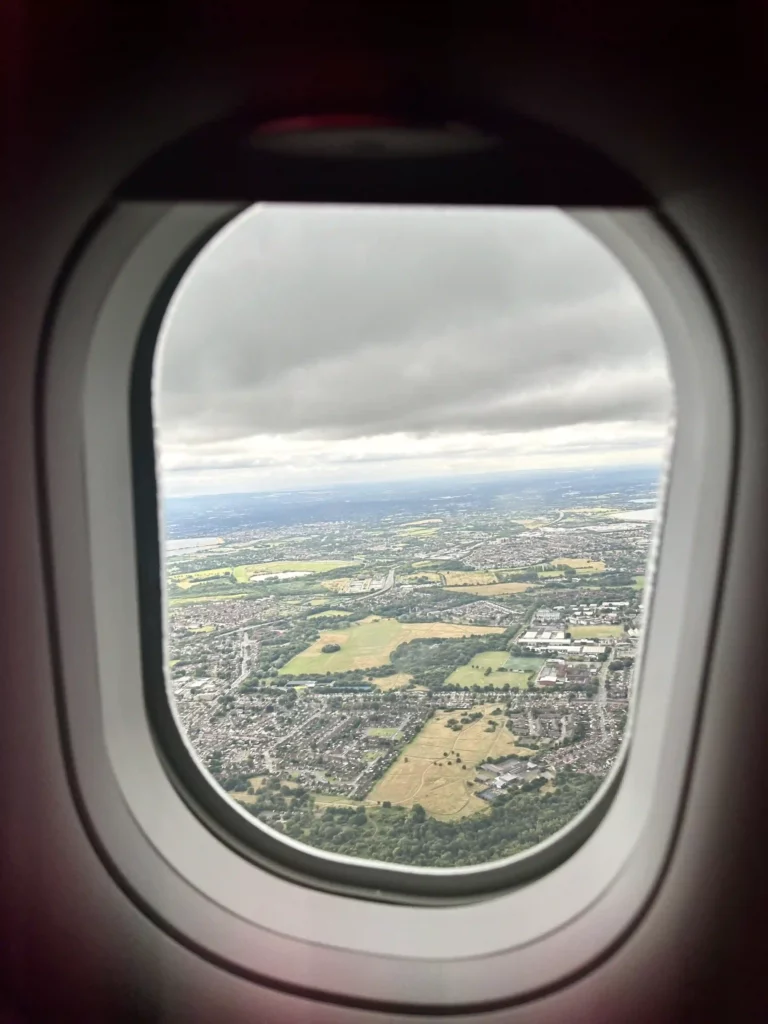 an airplane window with a view of a city