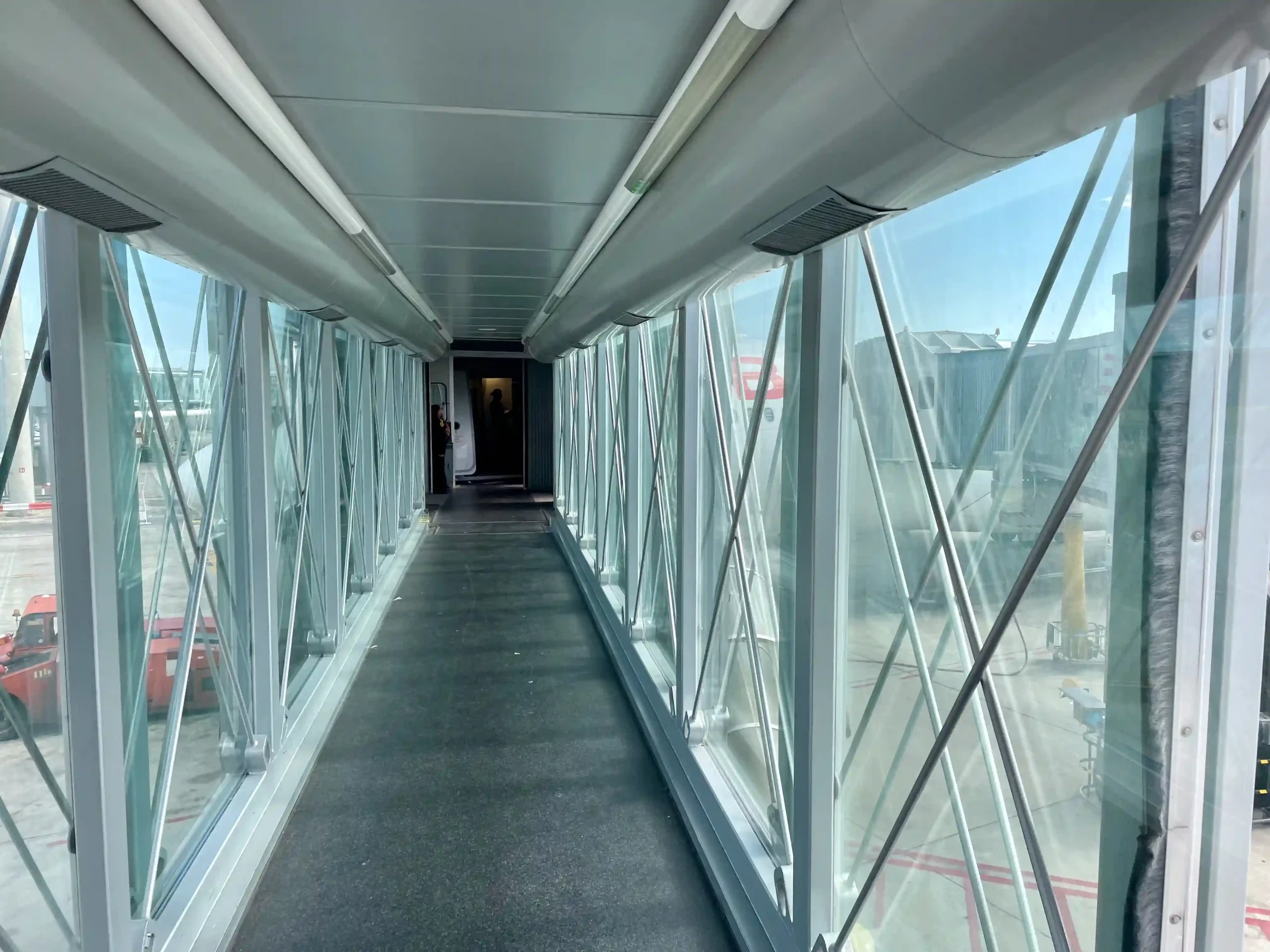 a long walkway with glass walls