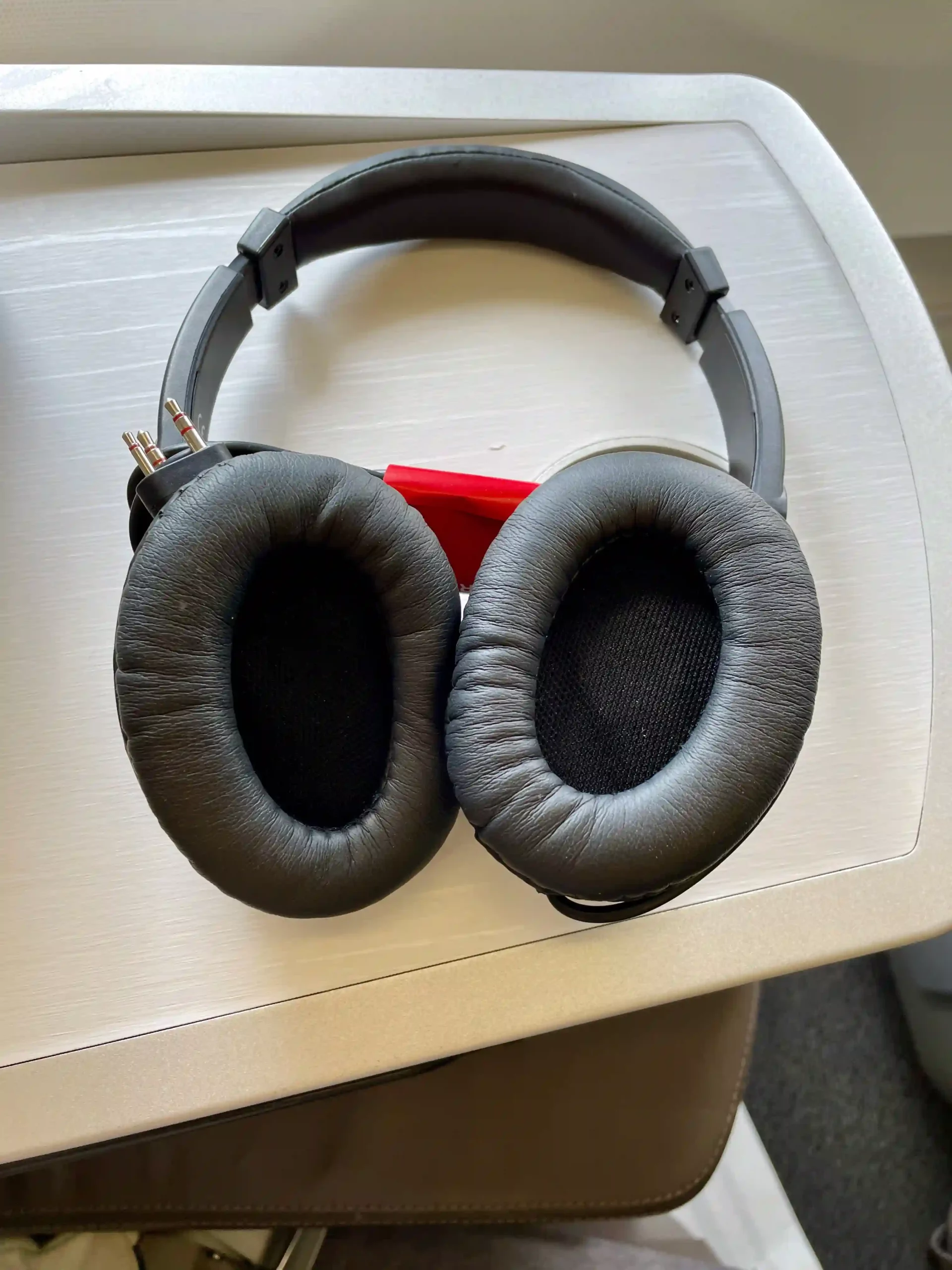 a pair of black headphones on a white table