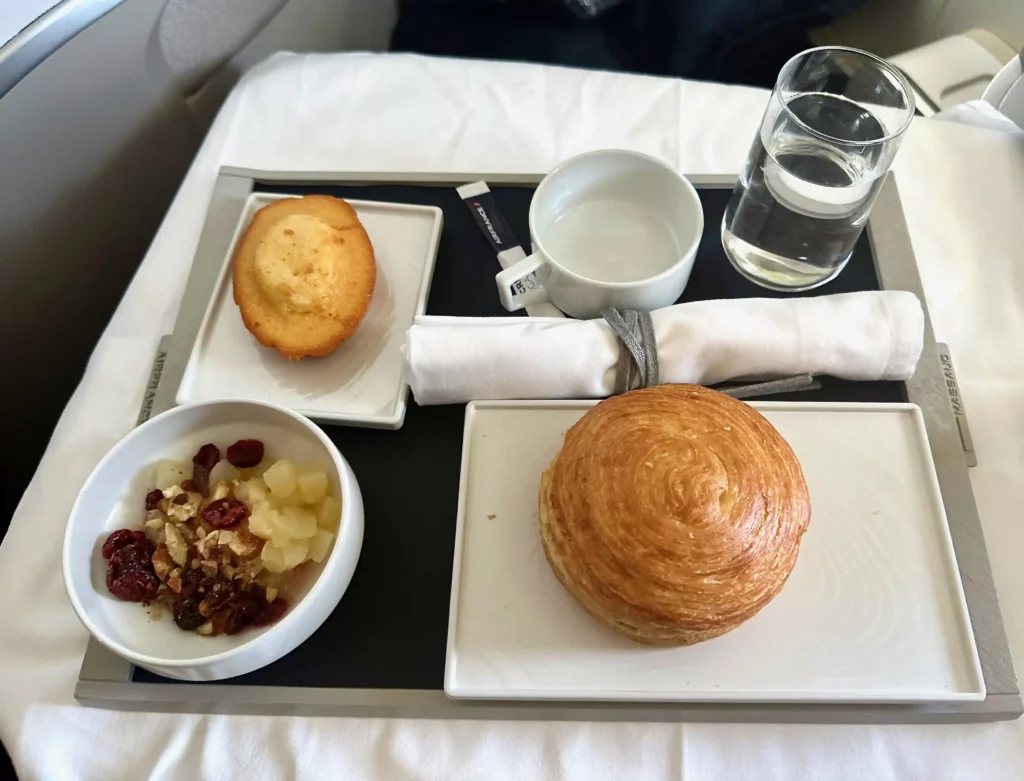 a tray with food and a cup of water on it