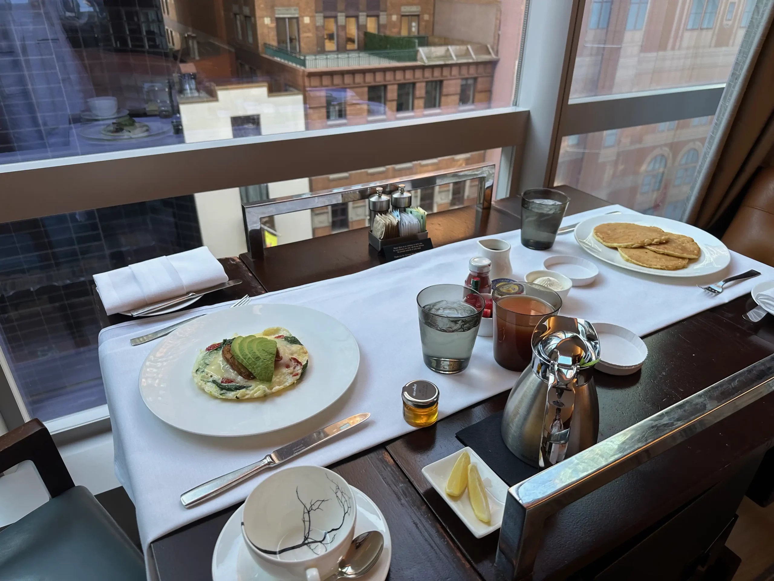 a table with plates of food and utensils on it