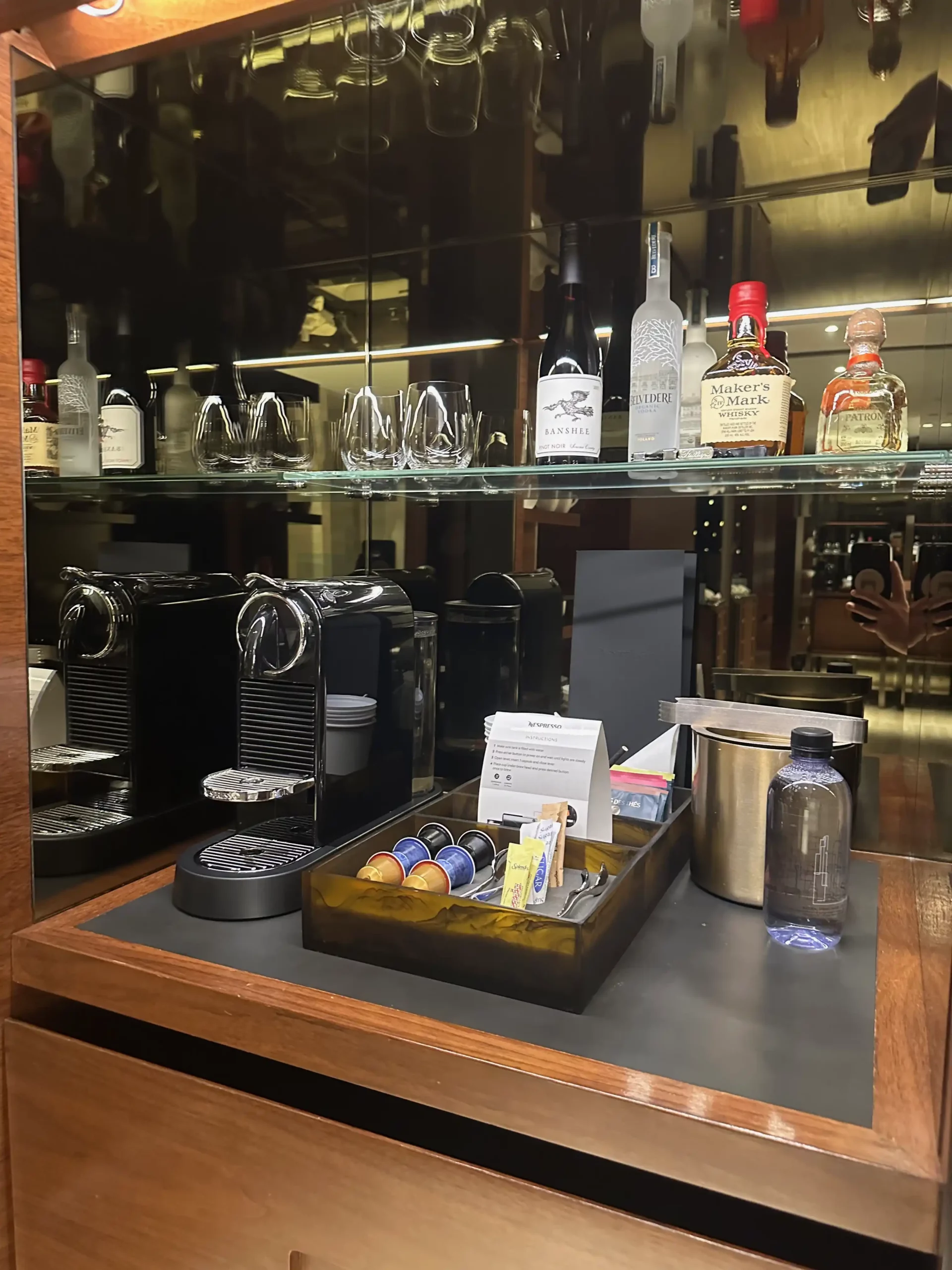 a shelf with liquor bottles and a coffee machine