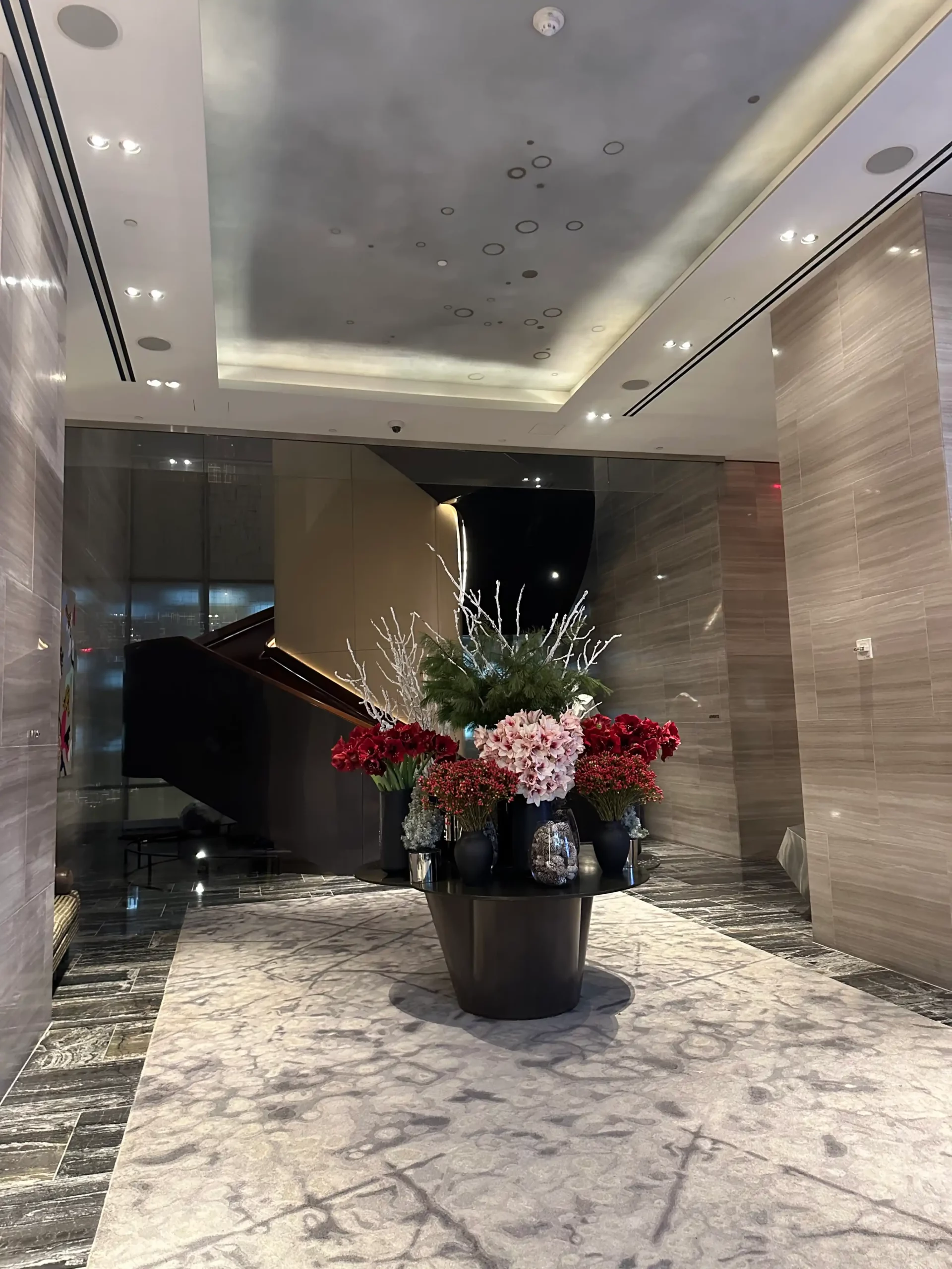 a large vase of flowers in a lobby