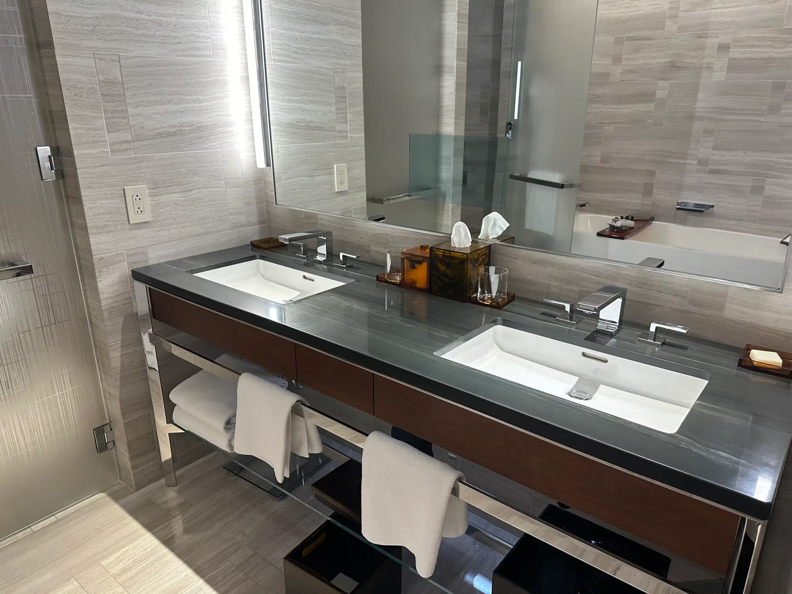 a bathroom with a large mirror and two sinks