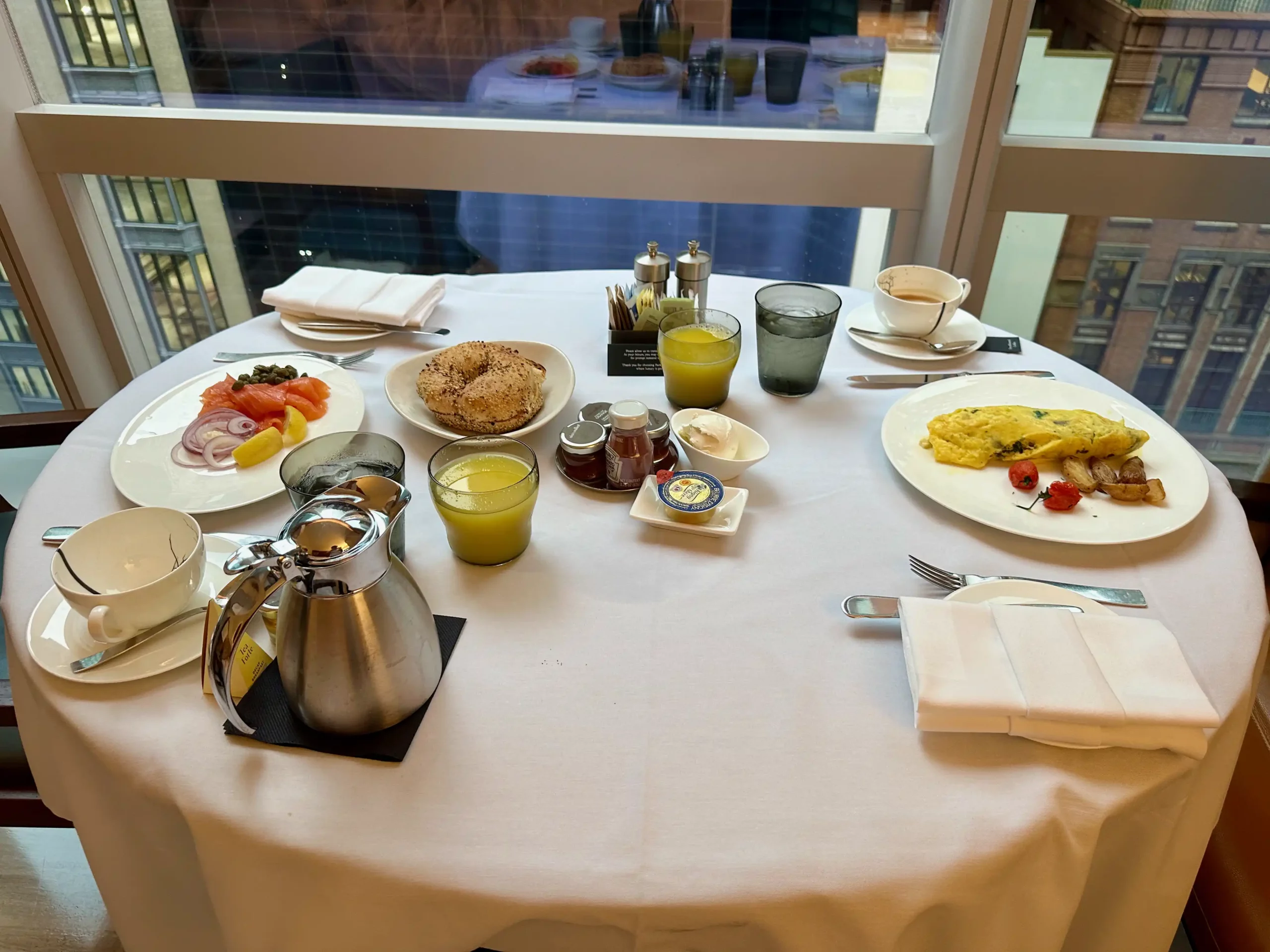 a table with plates of food and drinks