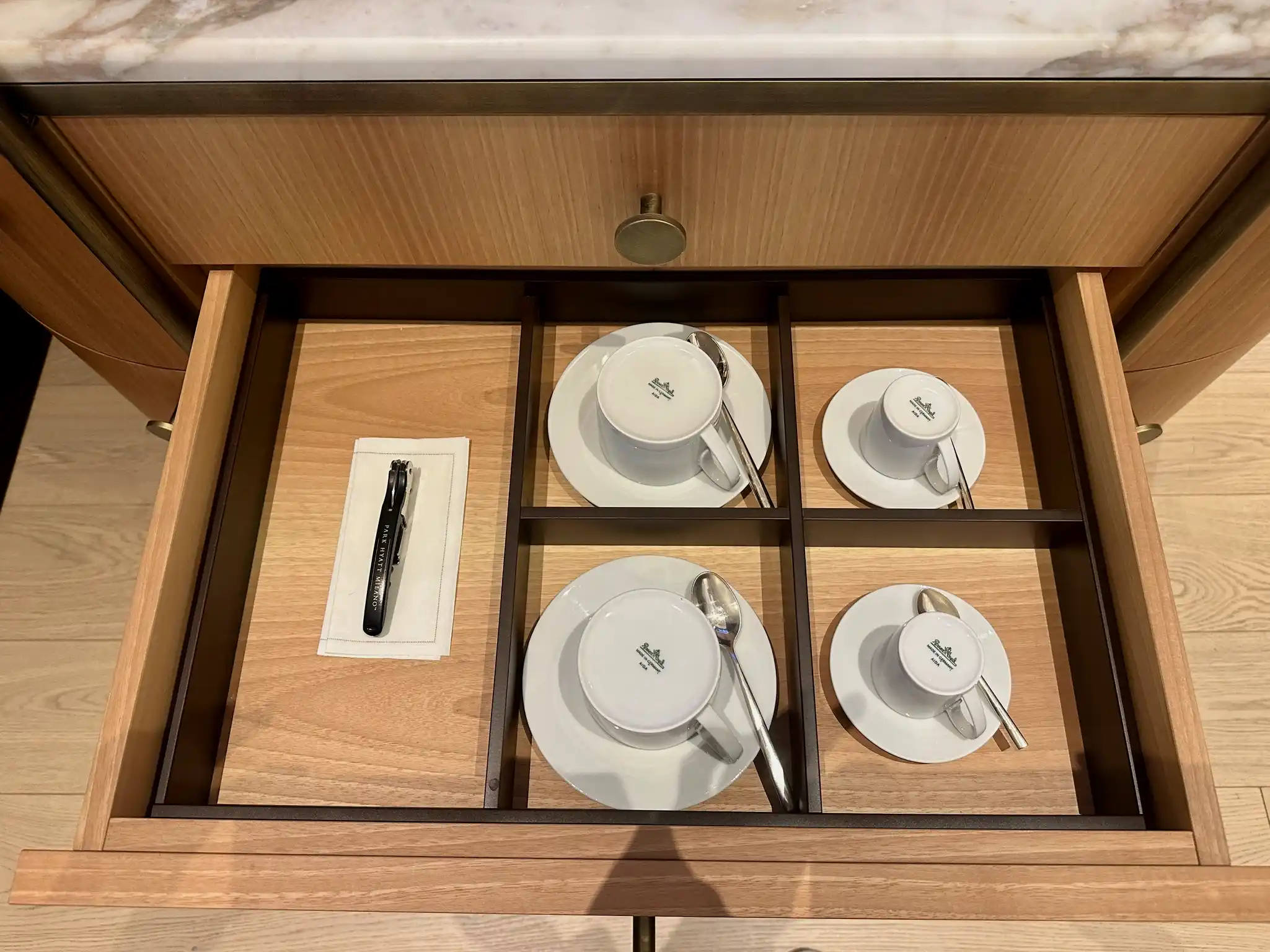 a drawer with a drawer full of teacups and saucers