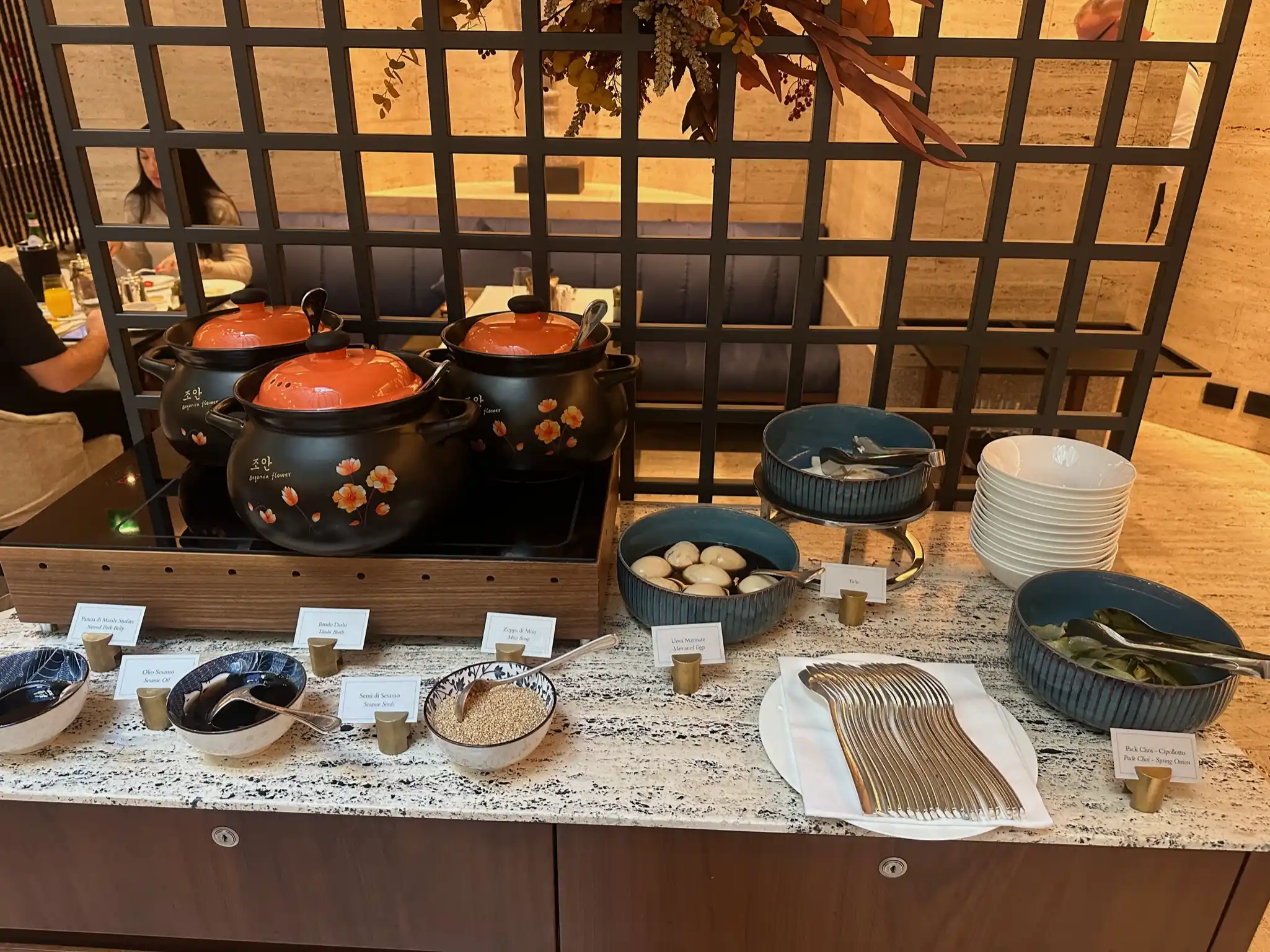 a table with bowls and bowls of food