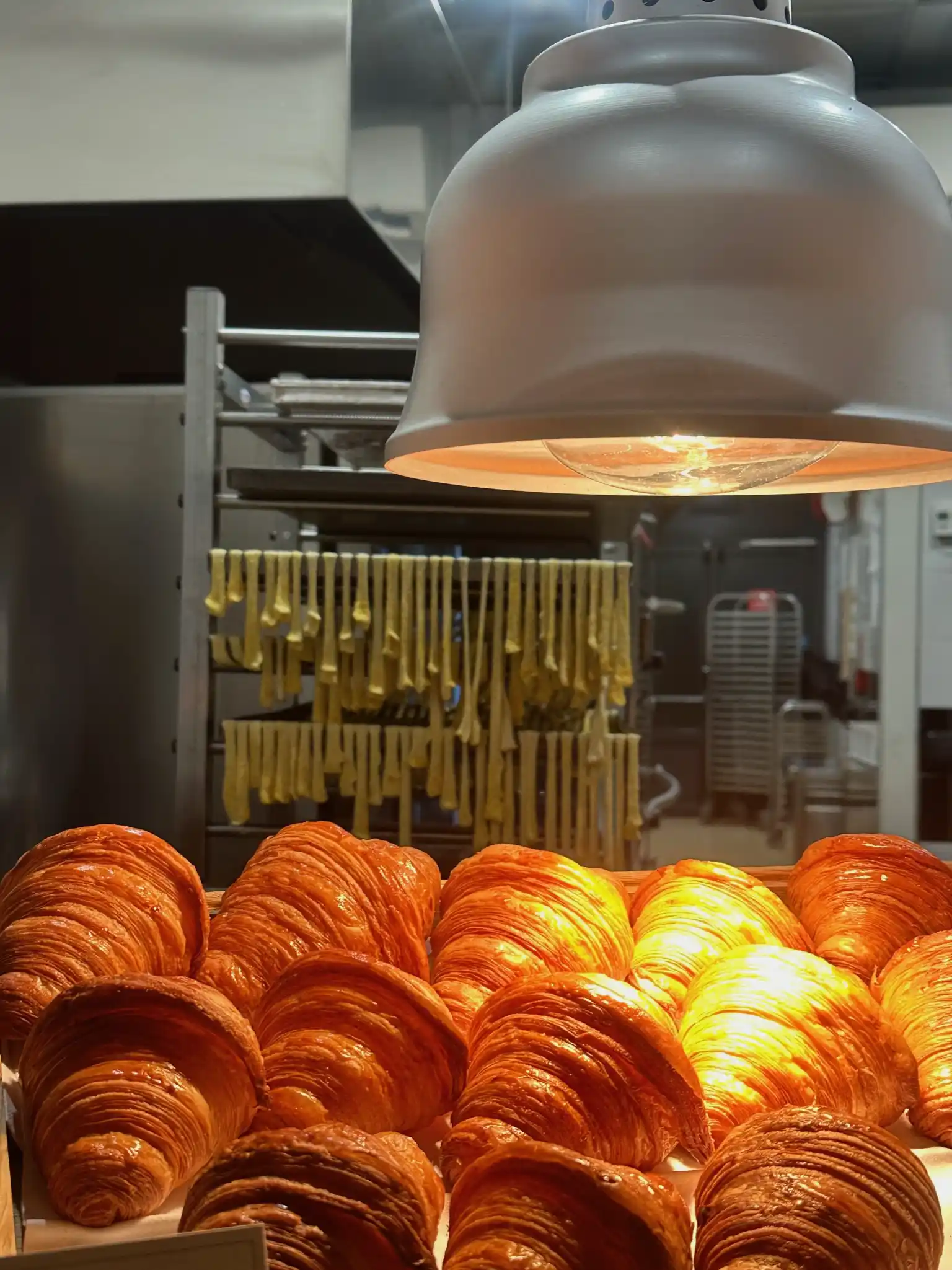 a group of croissants in a bakery